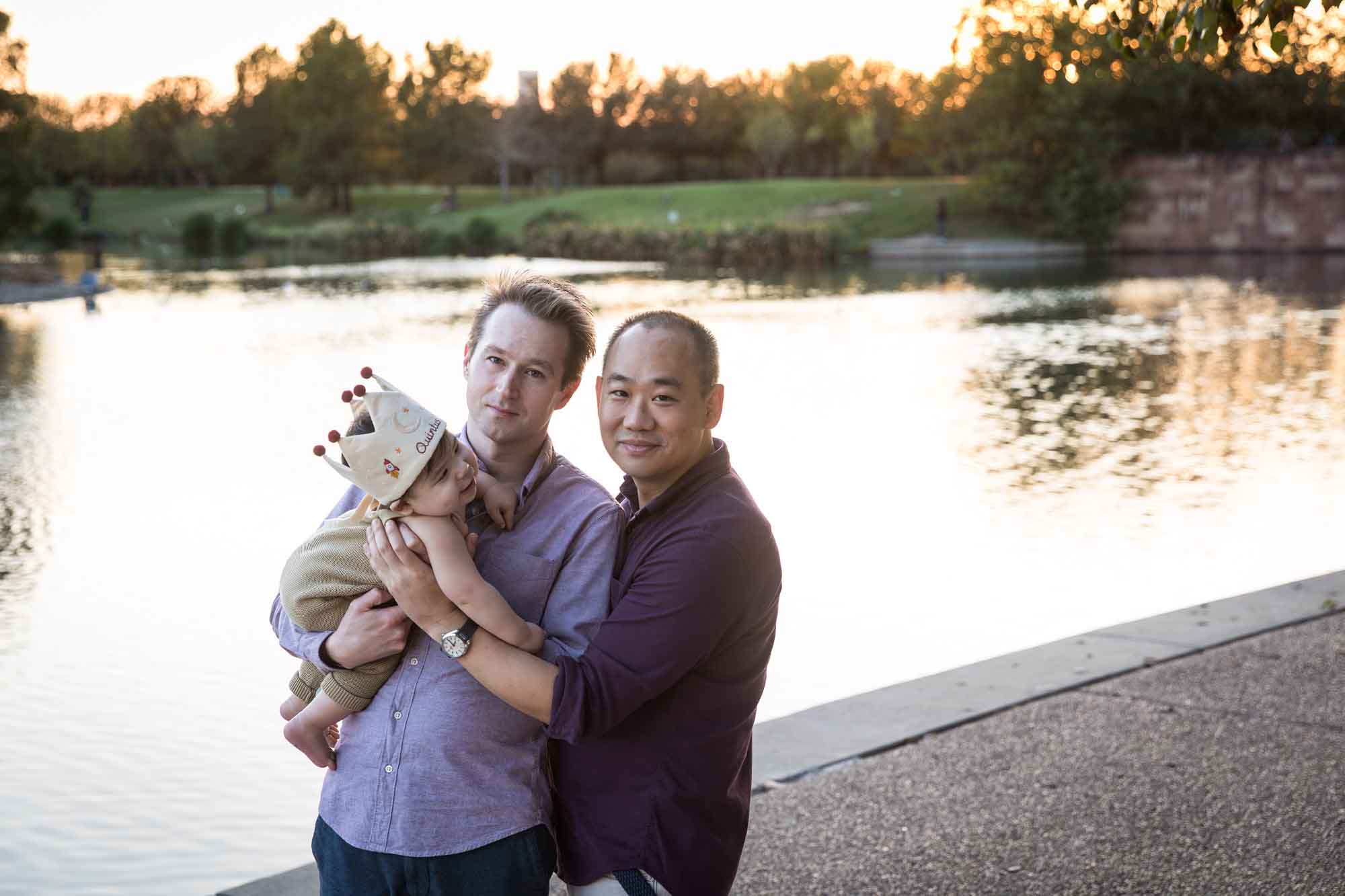 Two fathers and little boy standing beside Mueller Lake during a Mueller Lake Park family portrait