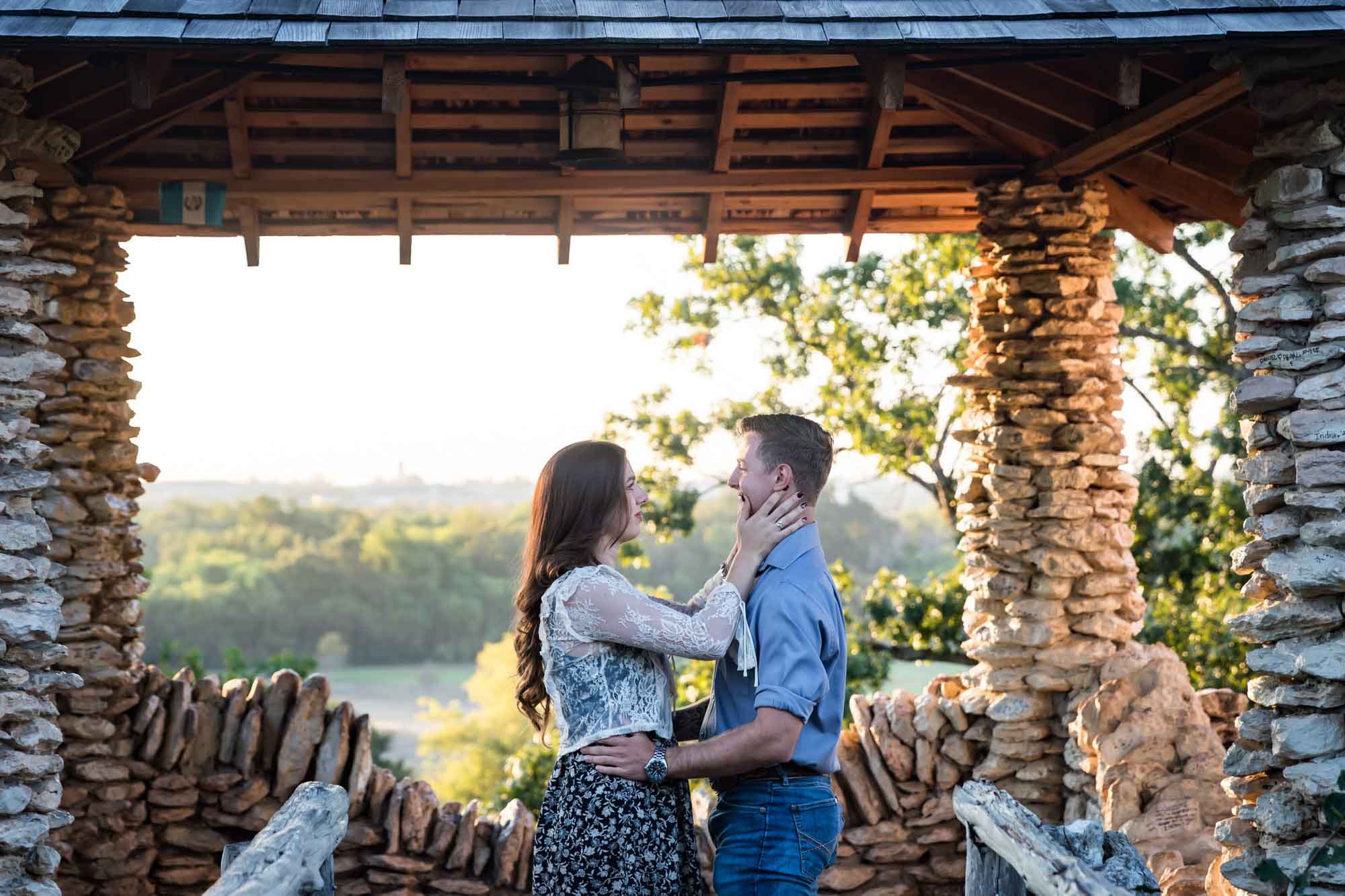 Couple hugging in middle of stone building during a Japanese Tea Garden engagement portrait 