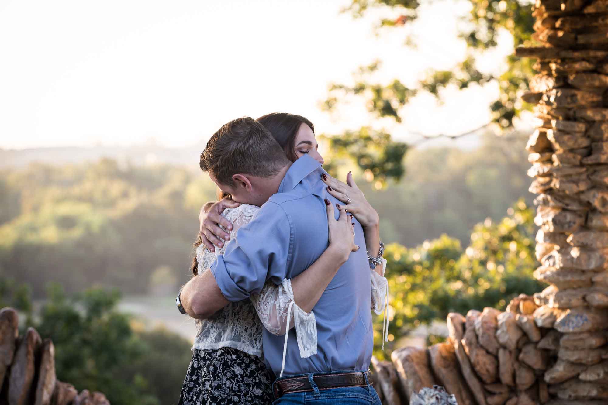 Couple hugging in middle of stone building during a Japanese Tea Garden engagement portrait 