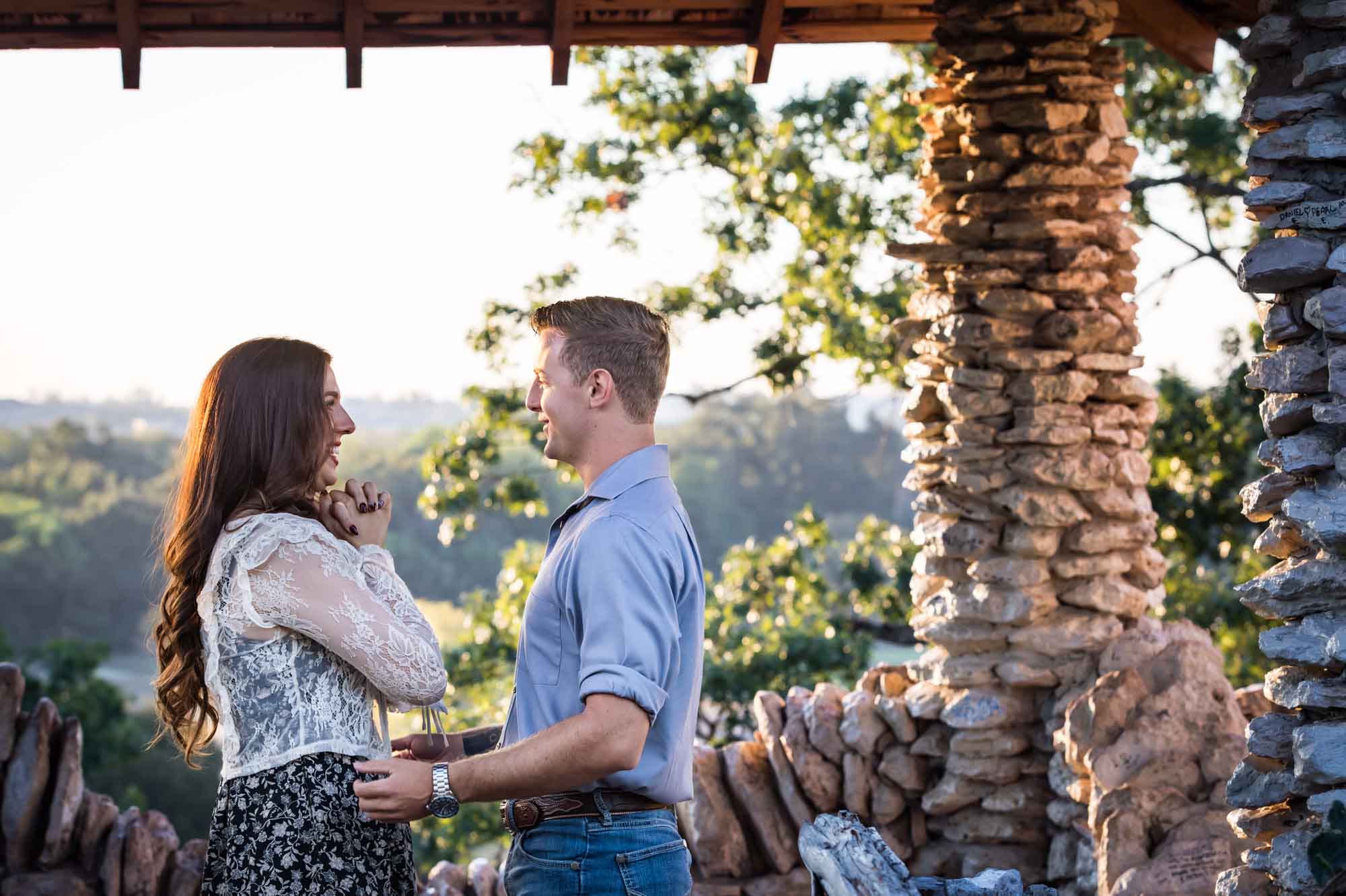 Couple hugging in middle of stone building during a Japanese Tea Garden engagement portrait 