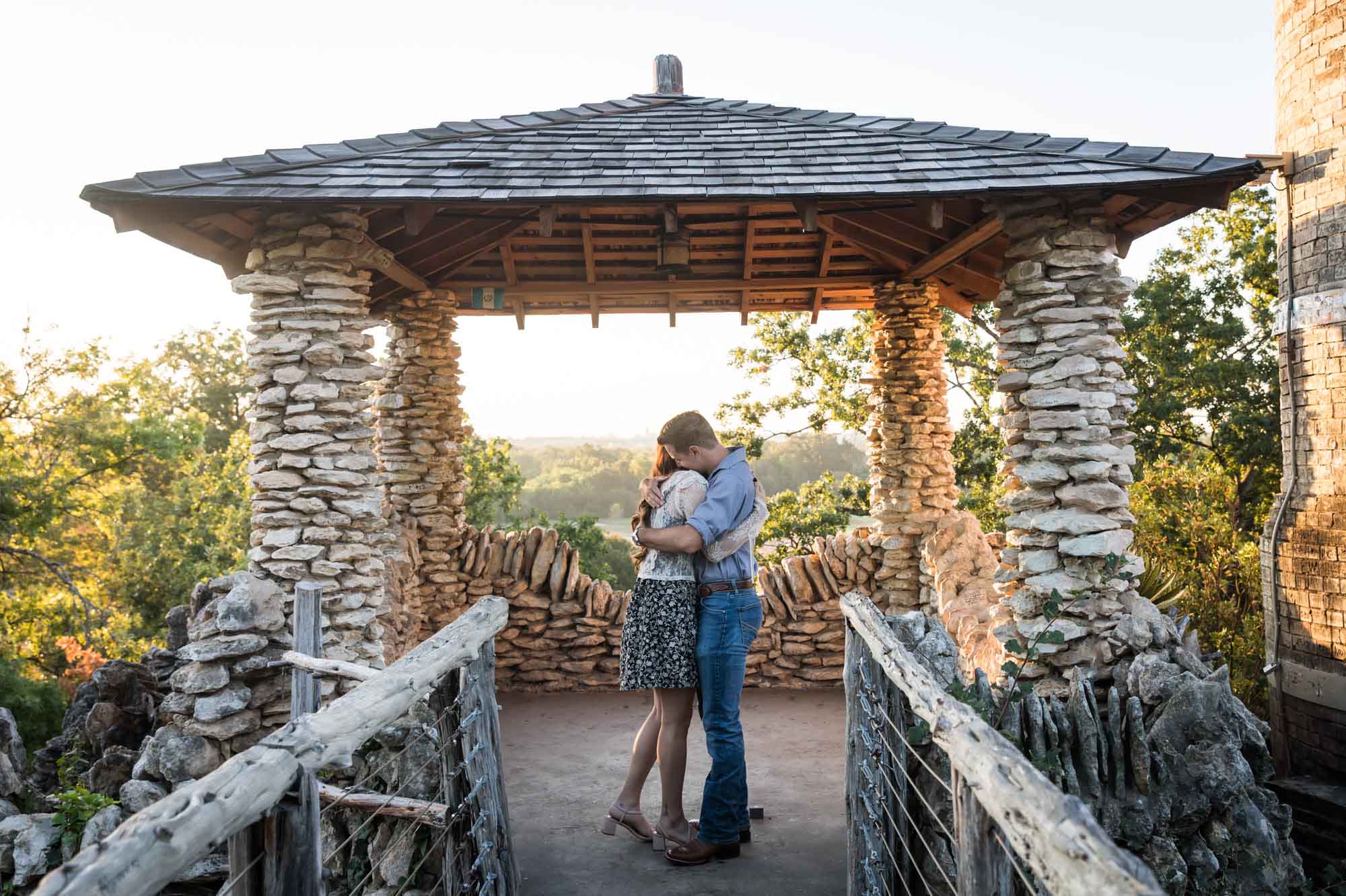 Couple hugging in middle of stone building at sunrise during a Japanese Tea Garden engagement portrait 