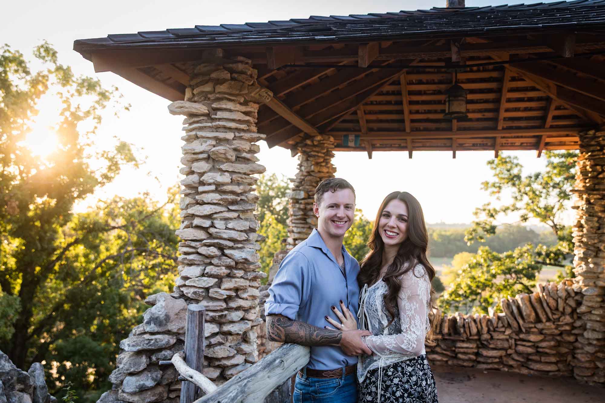 Couple hugging in front of stone building during a Japanese Tea Garden engagement portrait 