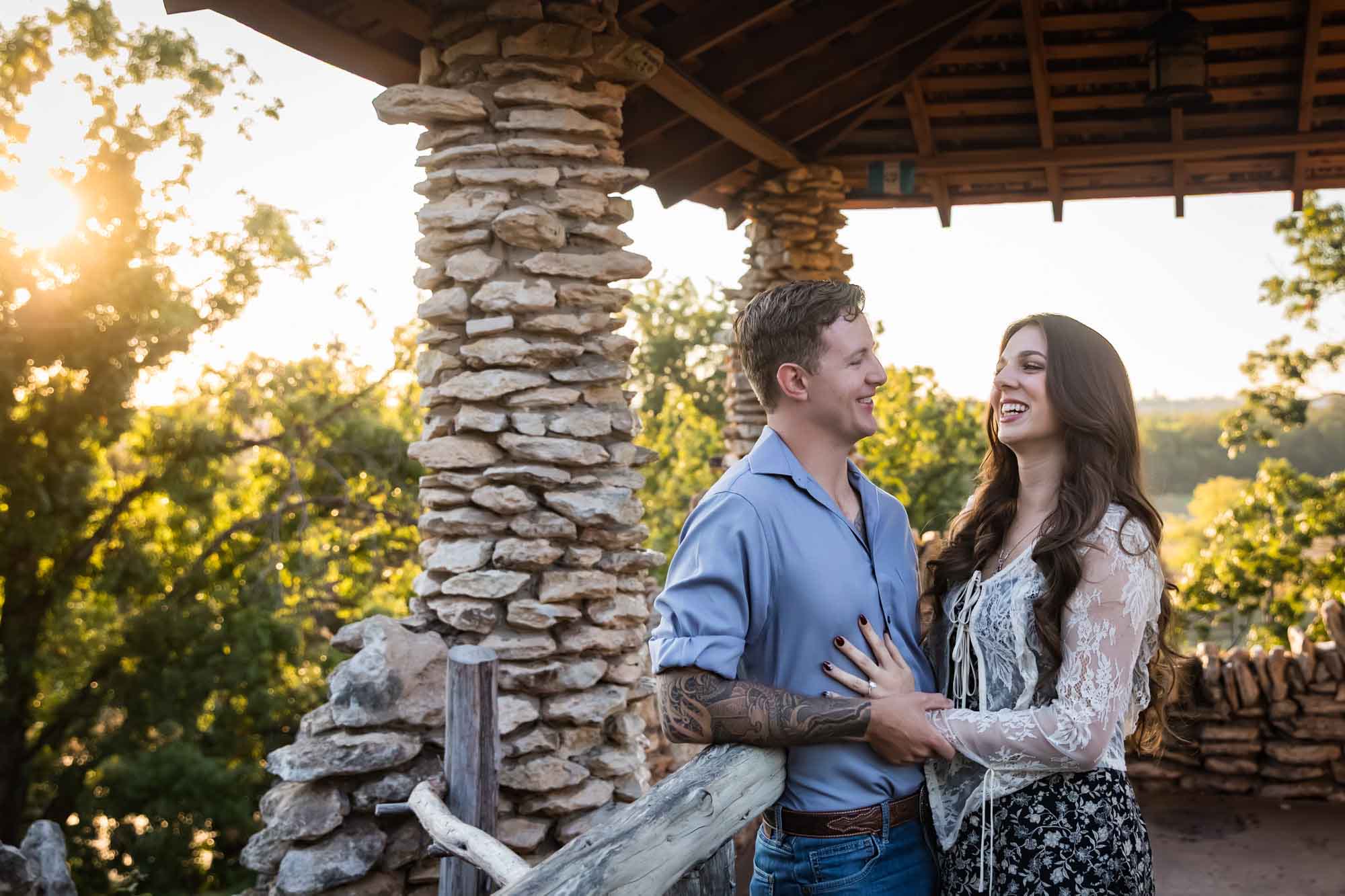 Couple hugging in front of stone building during a Japanese Tea Garden engagement portrait 