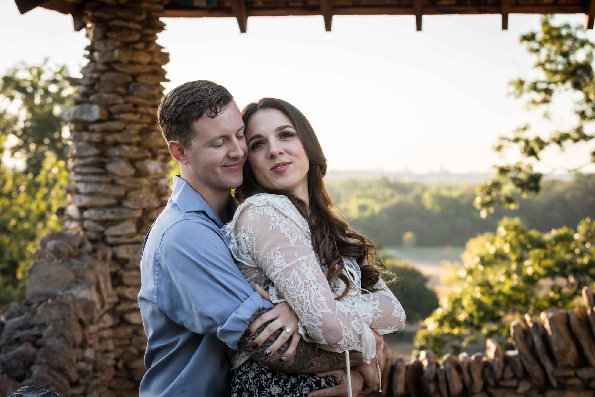 Couple hugging in front of stone building during a Japanese Tea Garden engagement portrait 