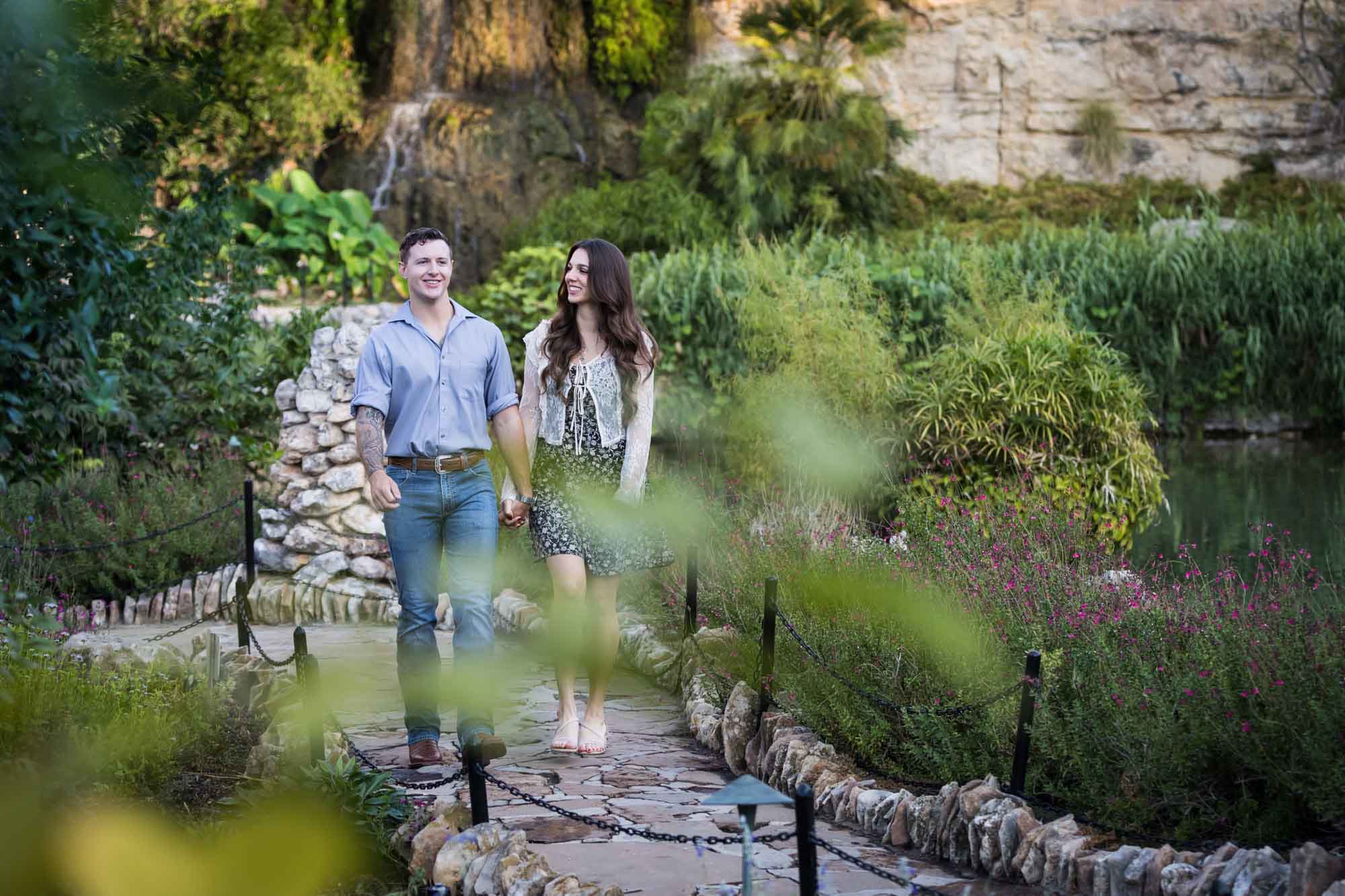 Couple holding hands and walking in the Japanese Tea Garden during an engagement shoot for an article on ‘Where do I Start with Wedding Planning?’