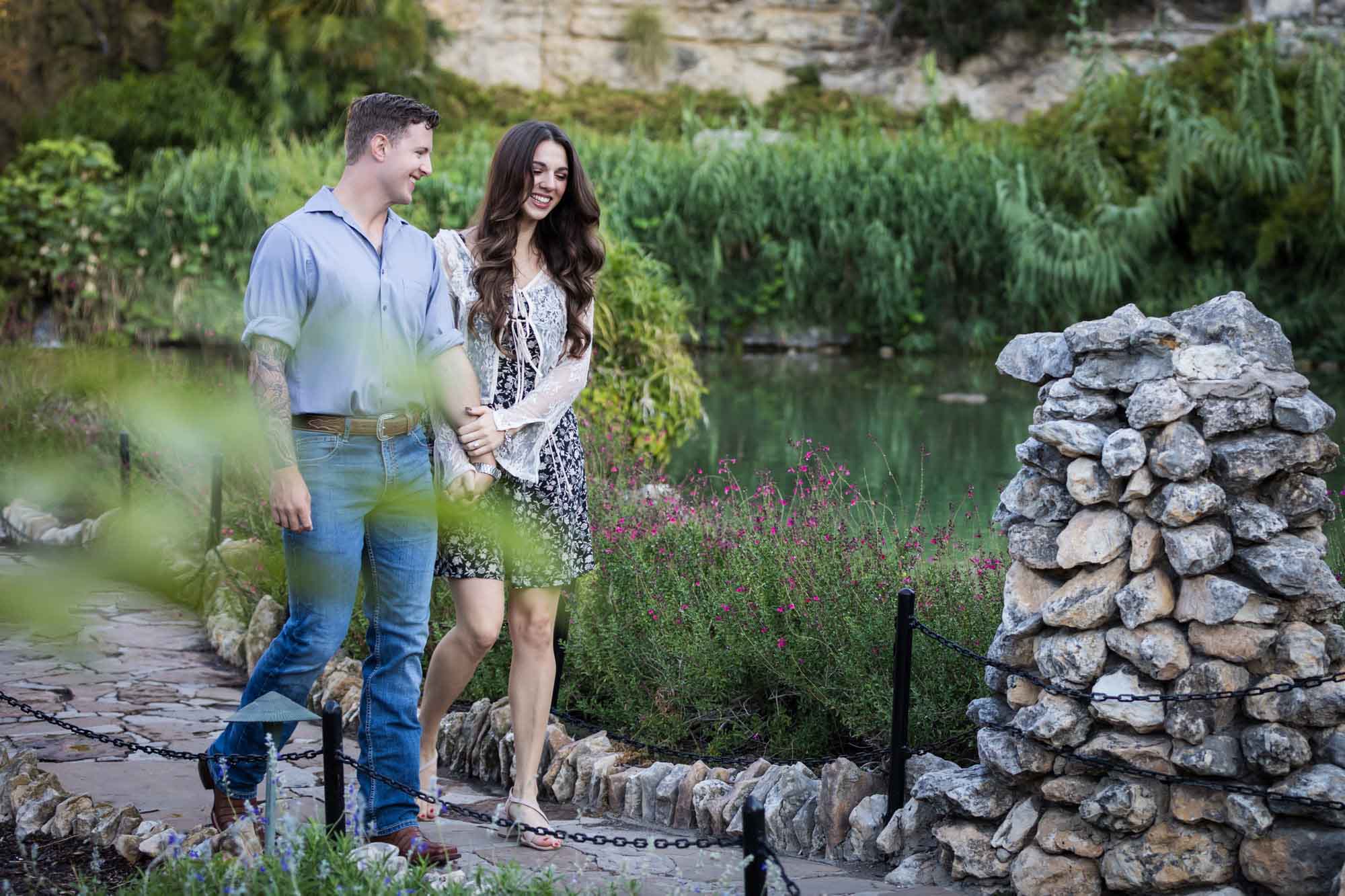 Couple holding hands and walking in the Japanese Tea Garden during an engagement shoot for an article on ‘Where do I Start with Wedding Planning?’