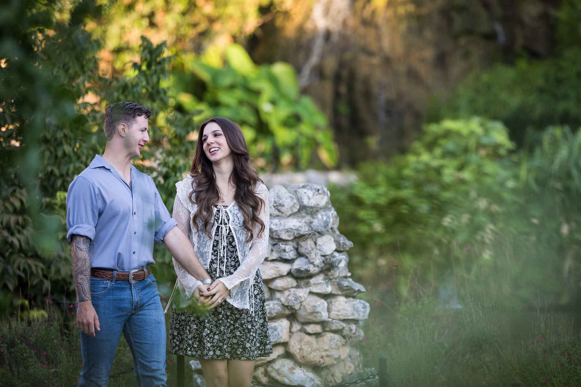 Couple holding hands and walking in the Japanese Tea Garden during an engagement shoot for an article on ‘Where do I Start with Wedding Planning?’