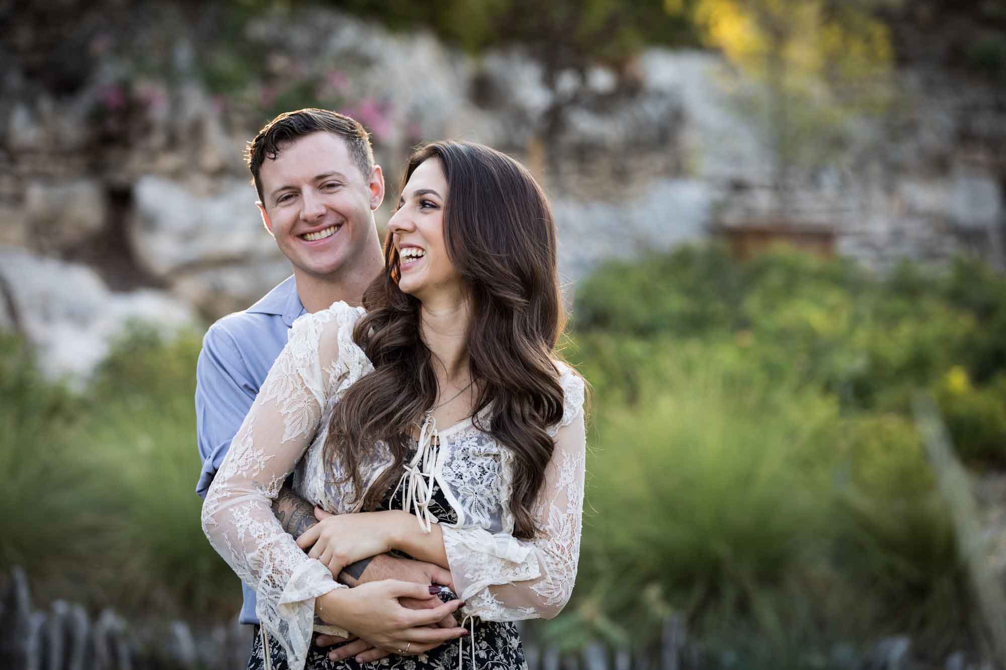 Couple hugging in the Japanese Tea Garden during an engagement shoot for an article on ‘Where do I Start with Wedding Planning?’
