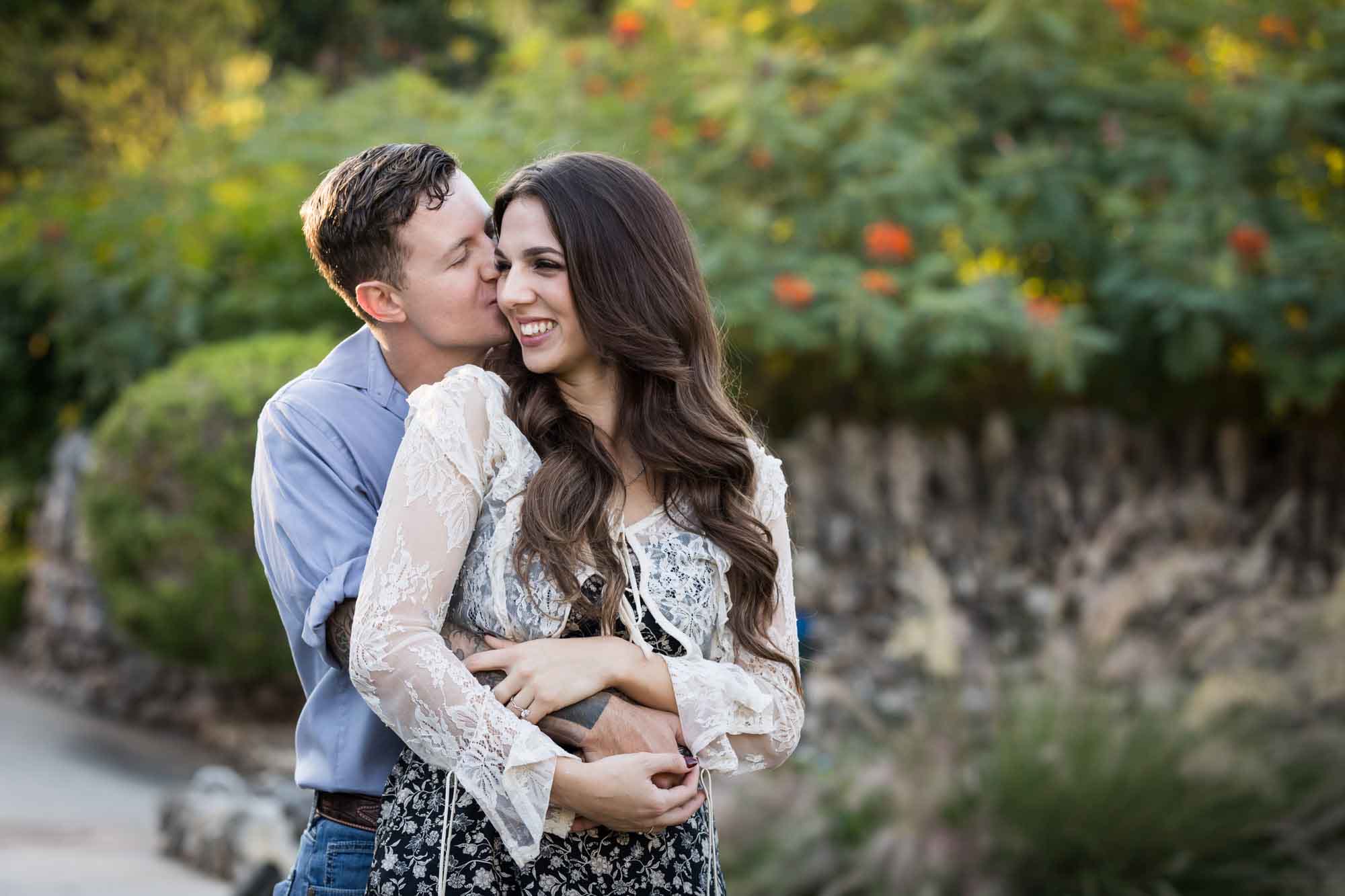 Couple kissing in the Japanese Tea Garden during an engagement shoot for an article on ‘Where do I Start with Wedding Planning?’