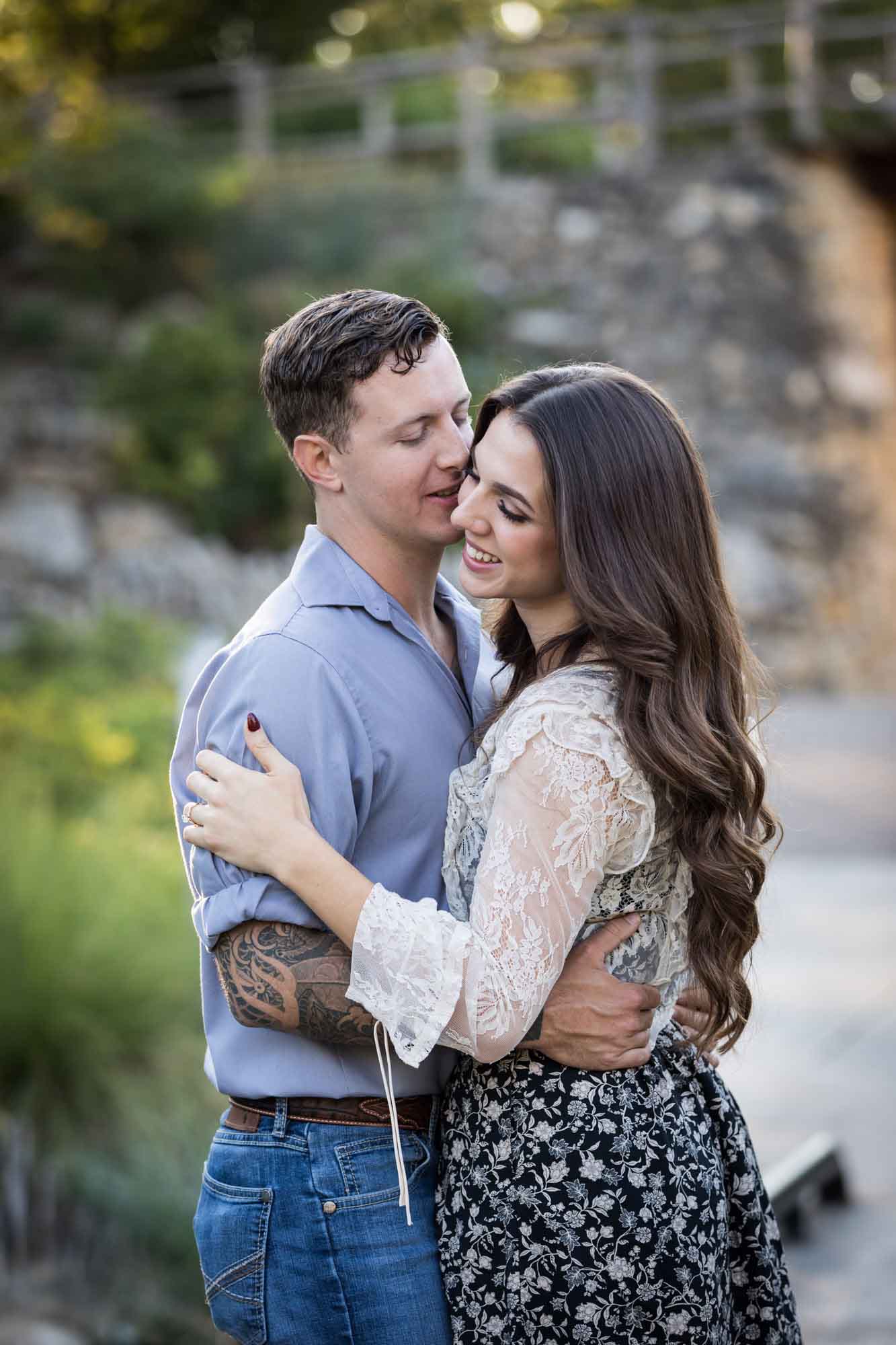Couple kissing in the Japanese Tea Garden during an engagement shoot for an article on ‘Where do I Start with Wedding Planning?’
