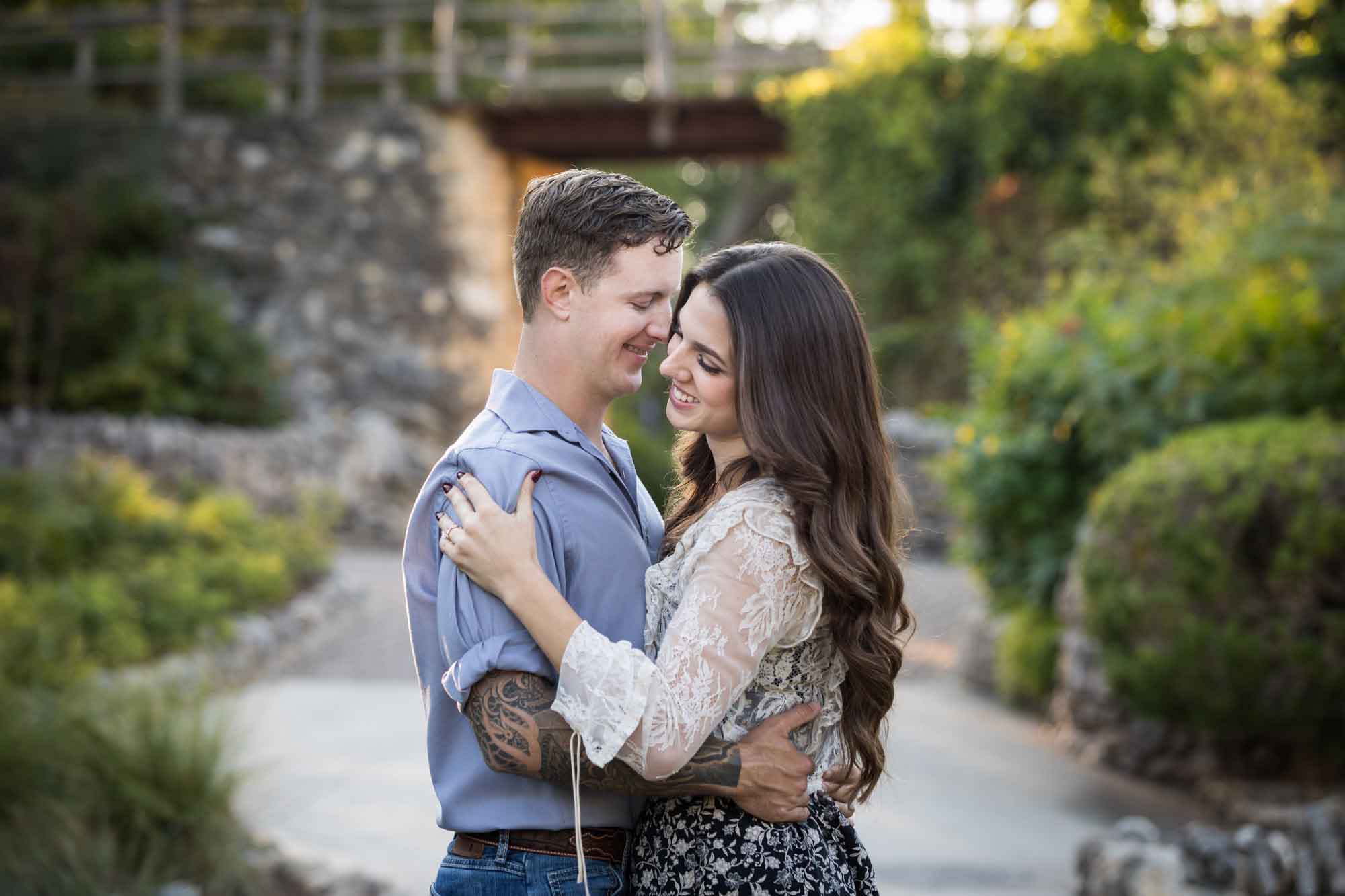 Couple hugging in the Japanese Tea Garden during an engagement shoot for an article on ‘Where do I Start with Wedding Planning?’