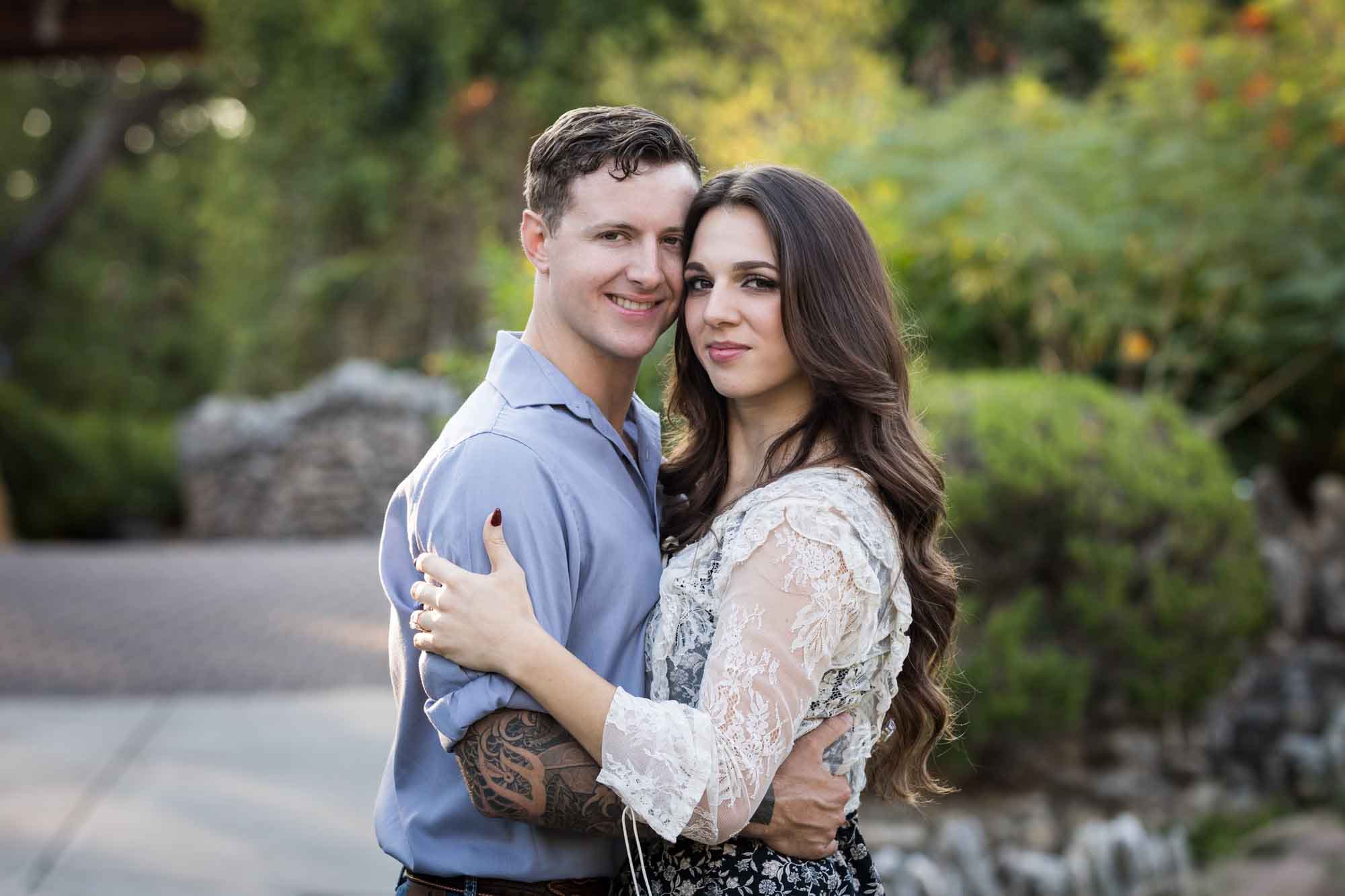 Couple hugging in the Japanese Tea Garden during an engagement shoot for an article on ‘Where do I Start with Wedding Planning?’