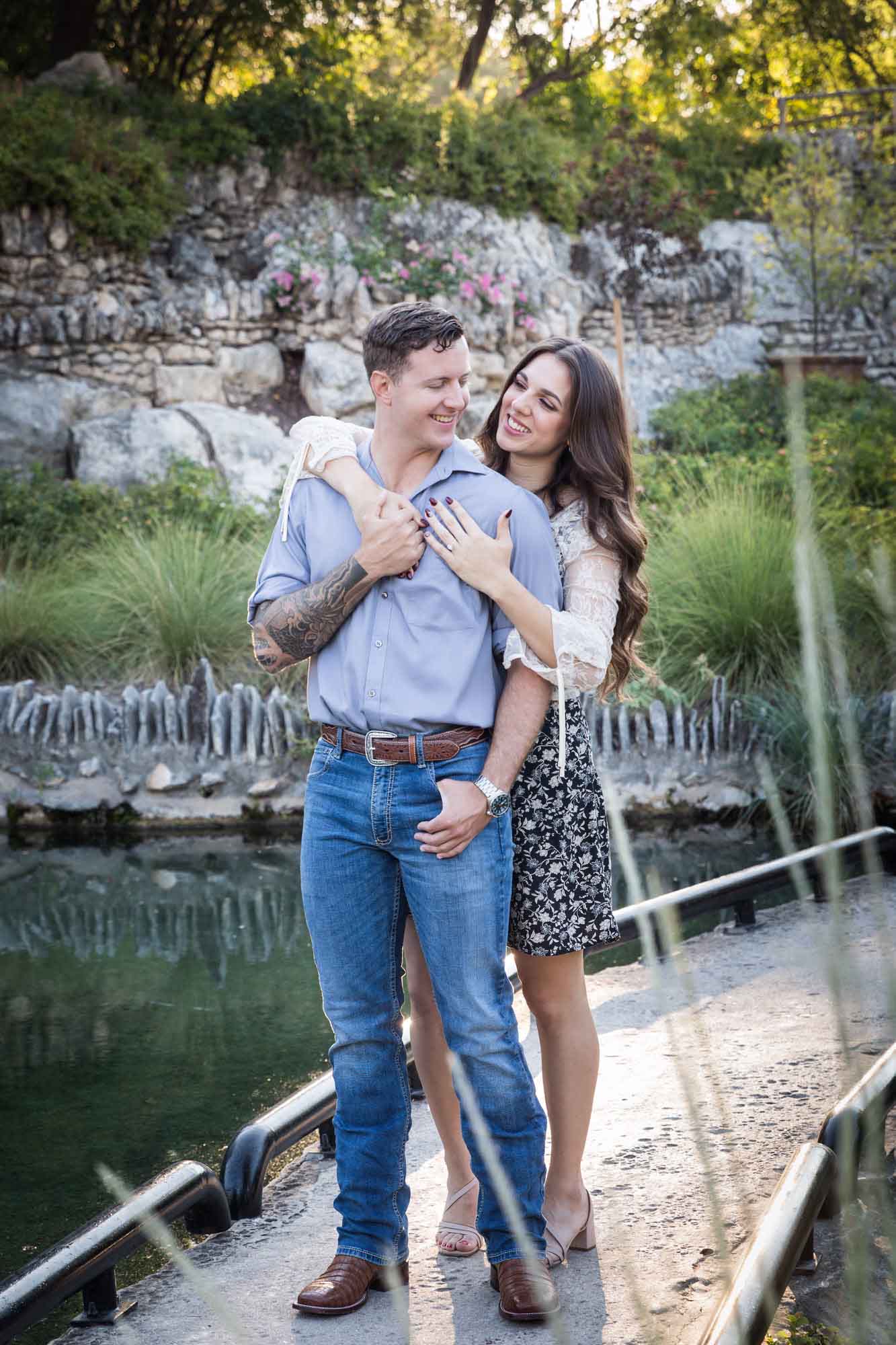 Woman hugging man from behind in the Japanese Tea Garden during an engagement shoot for an article on ‘Where do I Start with Wedding Planning?’