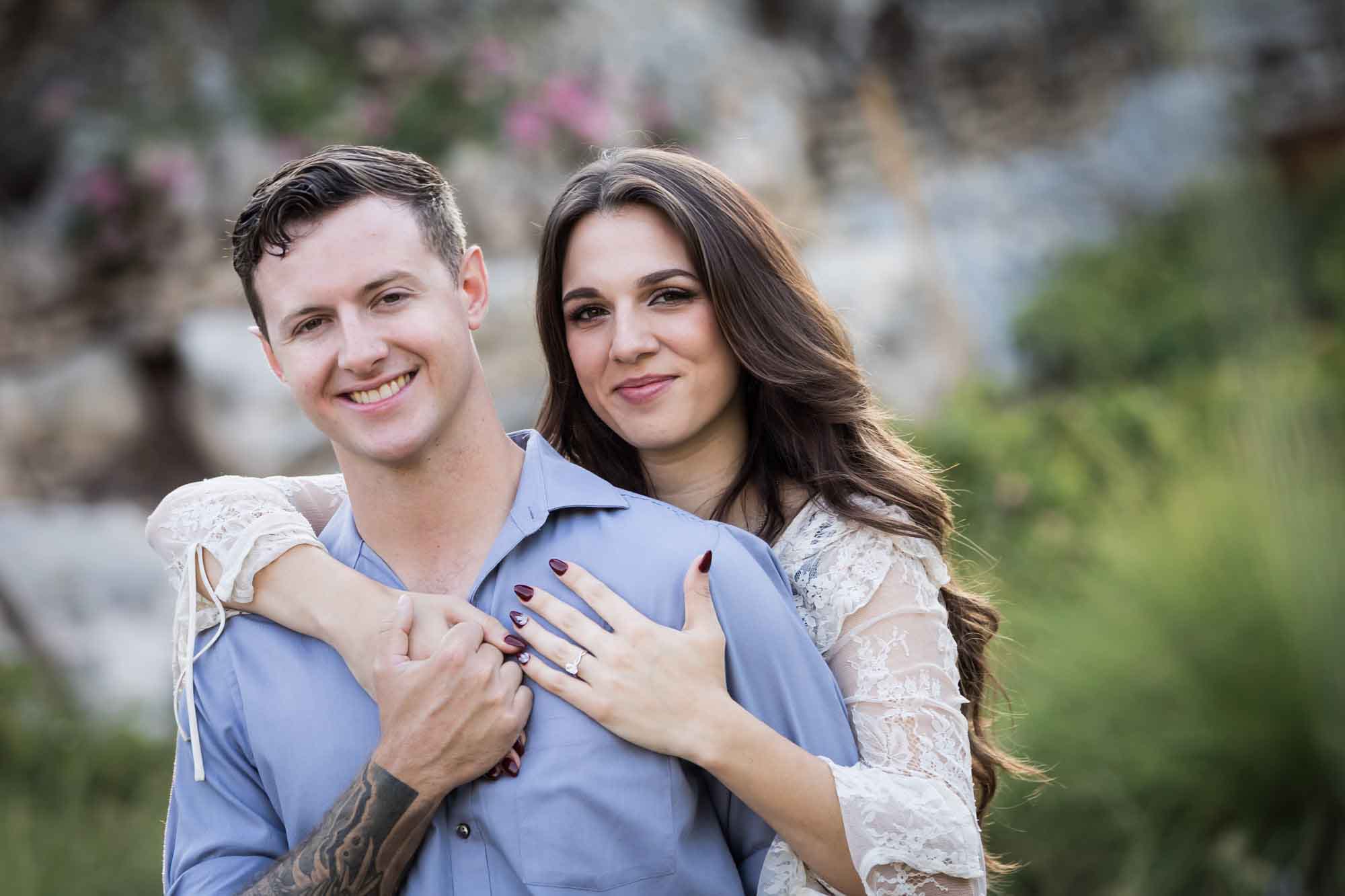Woman hugging man from behind in the Japanese Tea Garden during an engagement shoot for an article on ‘Where do I Start with Wedding Planning?’
