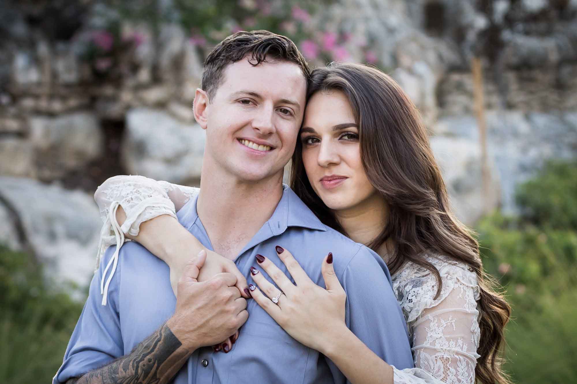 Woman hugging man from behind in the Japanese Tea Garden during an engagement shoot for an article on ‘Where do I Start with Wedding Planning?’