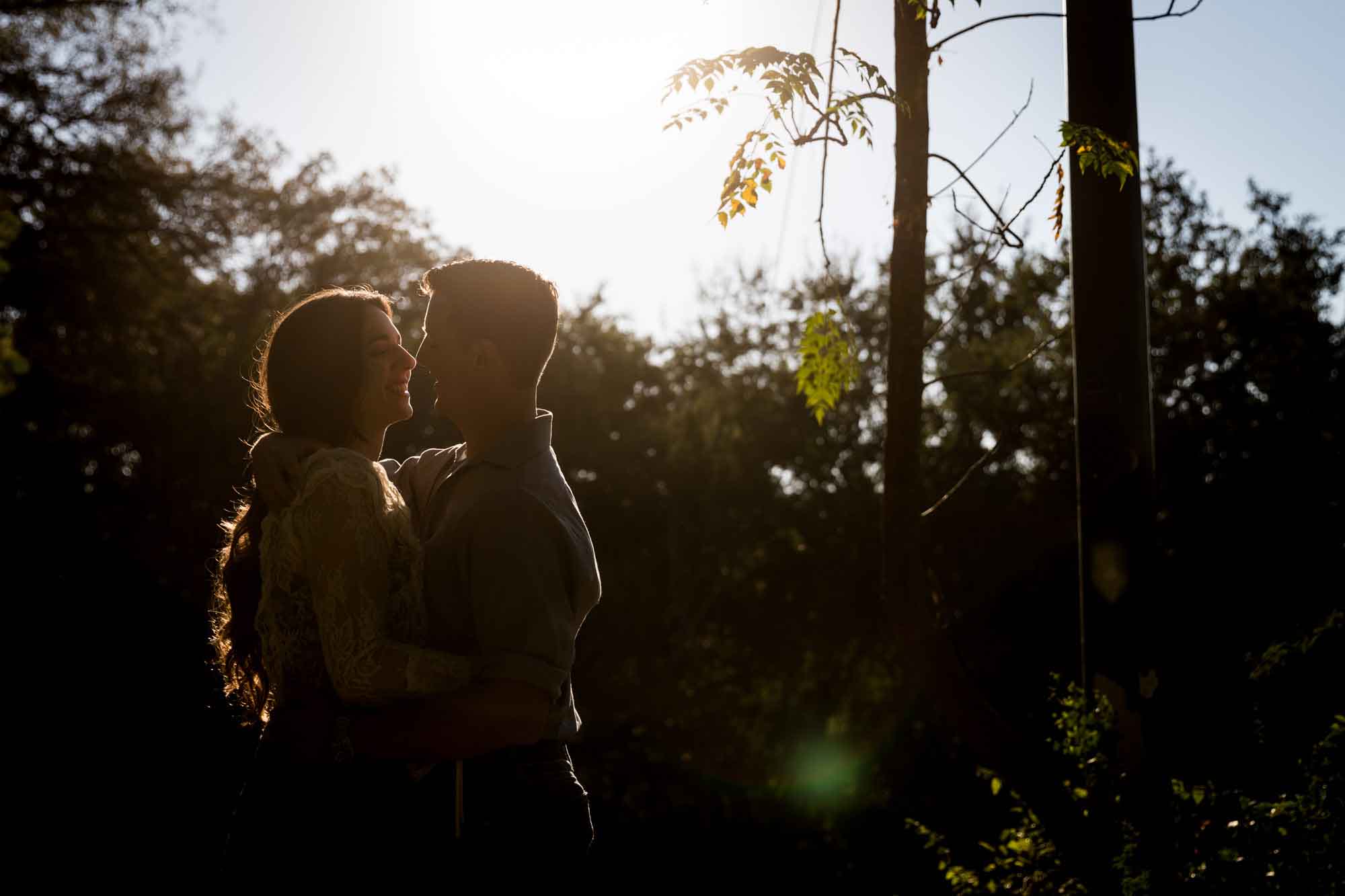 Couple hugging in silhouette at sunset for an article on ‘Where do I Start with Wedding Planning?’