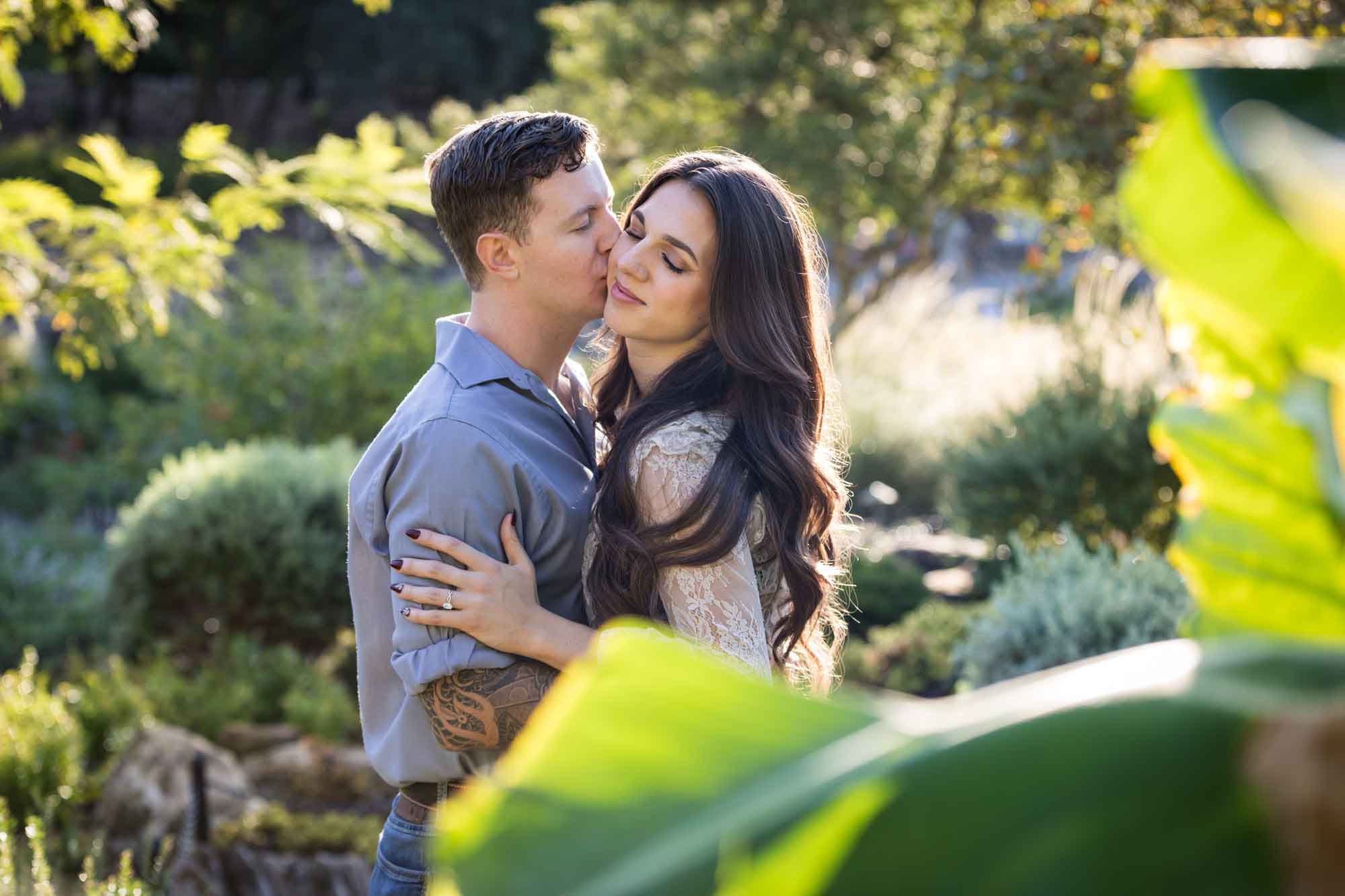 Couple hugging in Japanese Tea Garden for an article on ‘Where do I Start with Wedding Planning?’