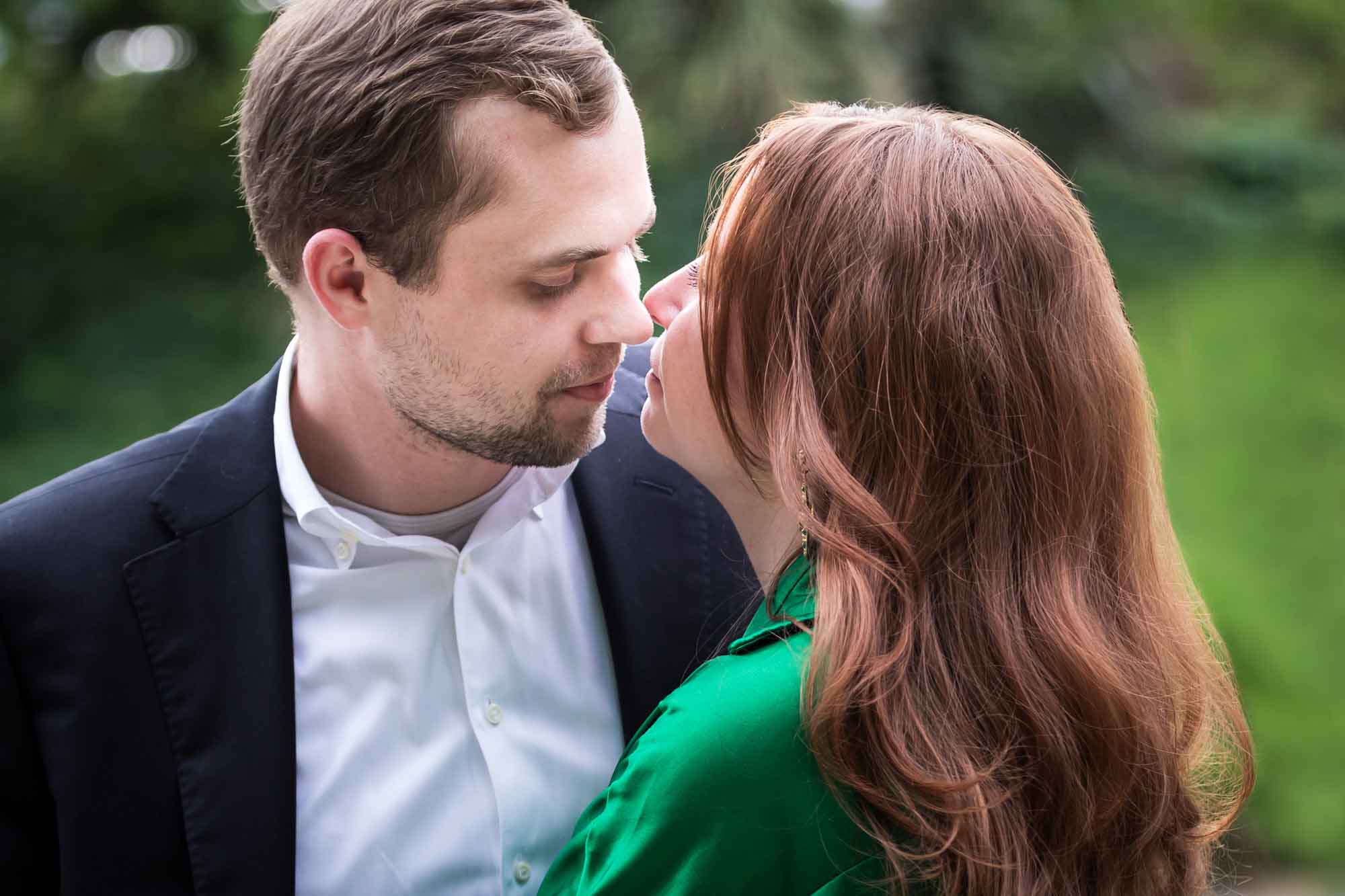 Man wearing black suit standing with woman wearing green blouse during an Emma Hotel surprise proposal