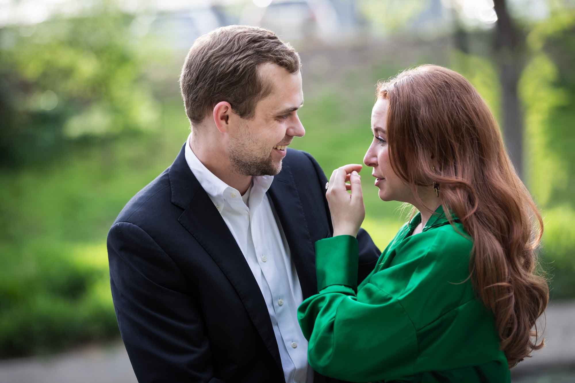 Man wearing black suit standing with woman wearing green blouse during an Emma Hotel surprise proposal