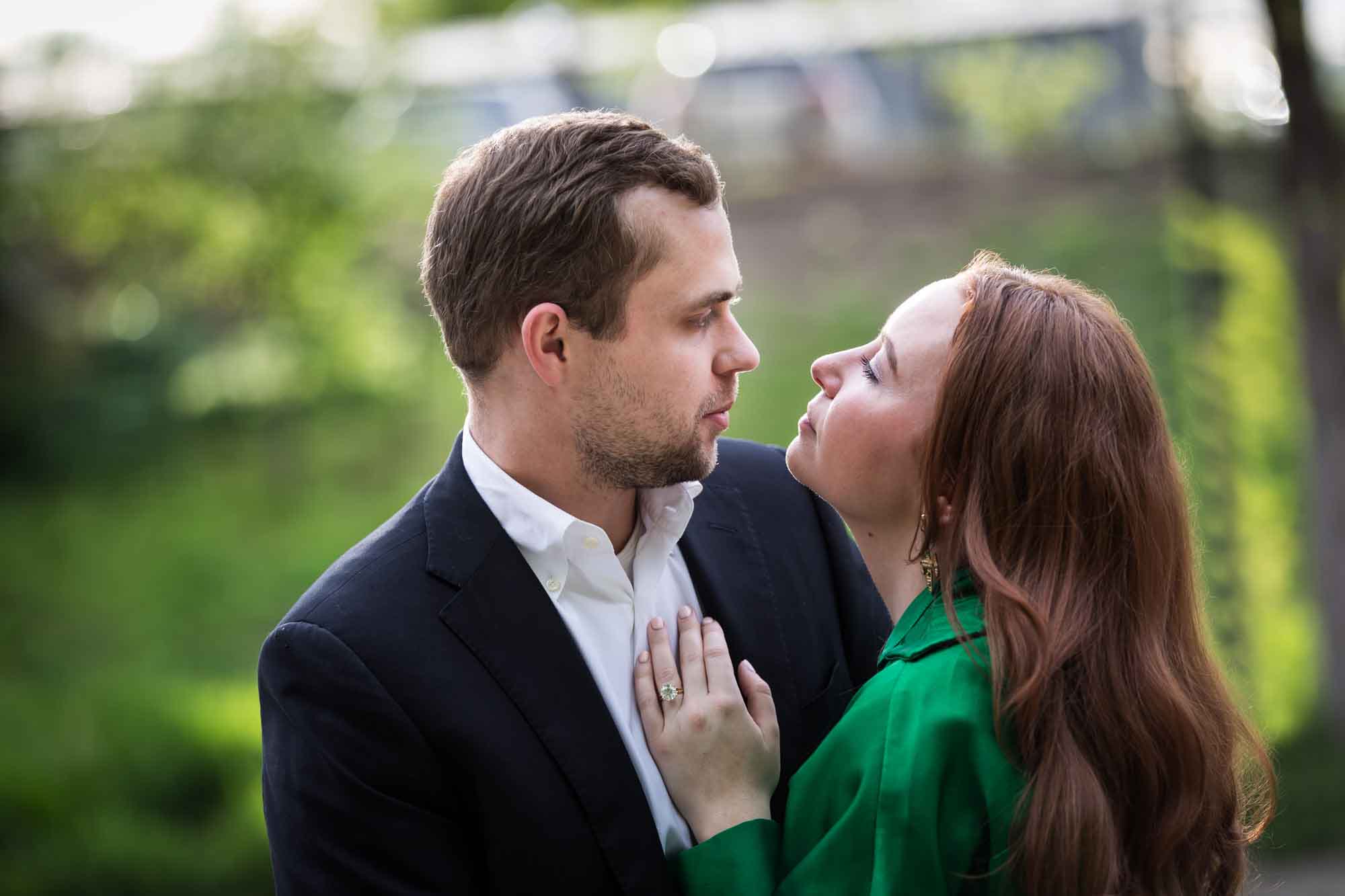 Man wearing black suit standing with woman wearing green blouse during an Emma Hotel surprise proposal
