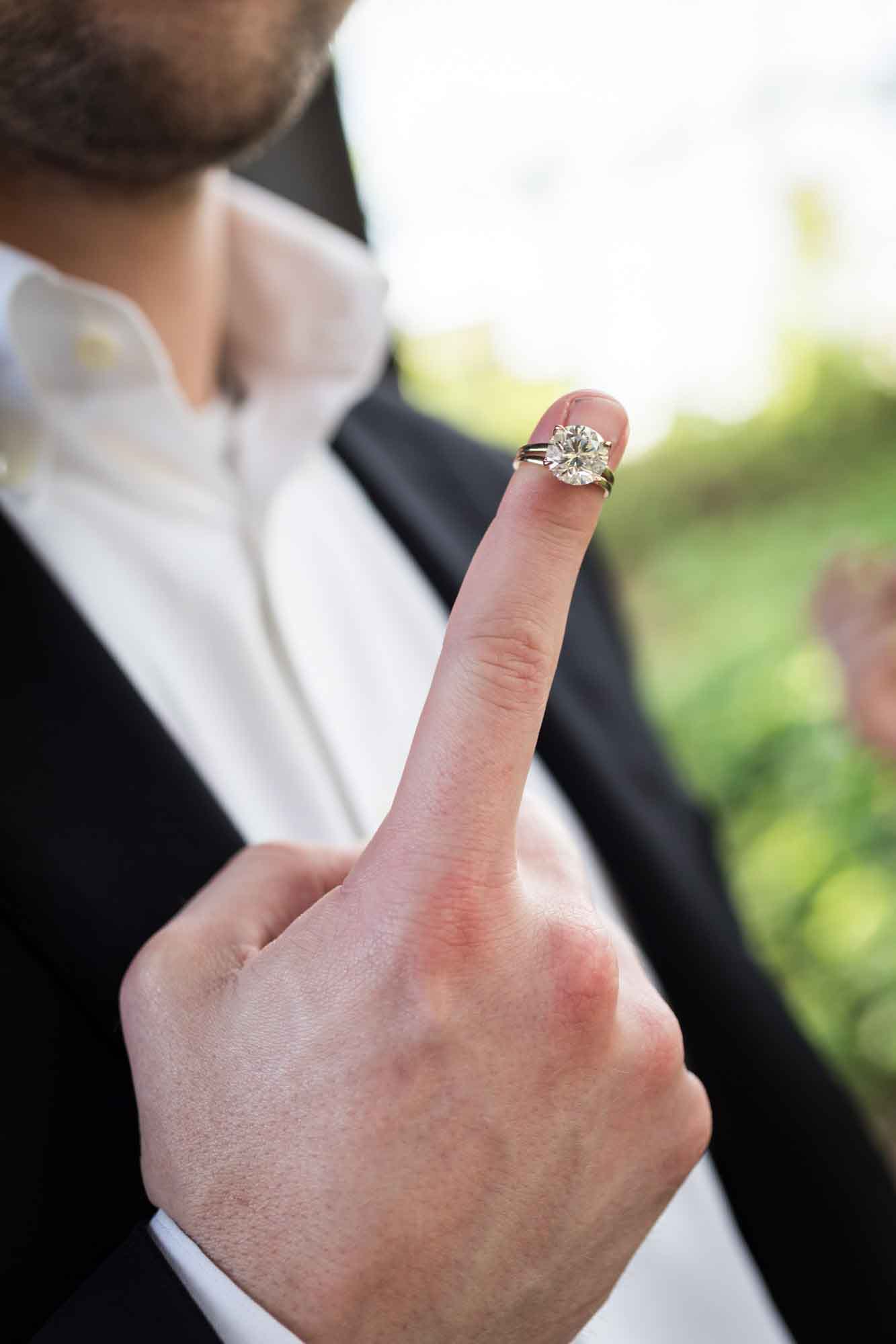 Close up of man's finger showing engagement ring