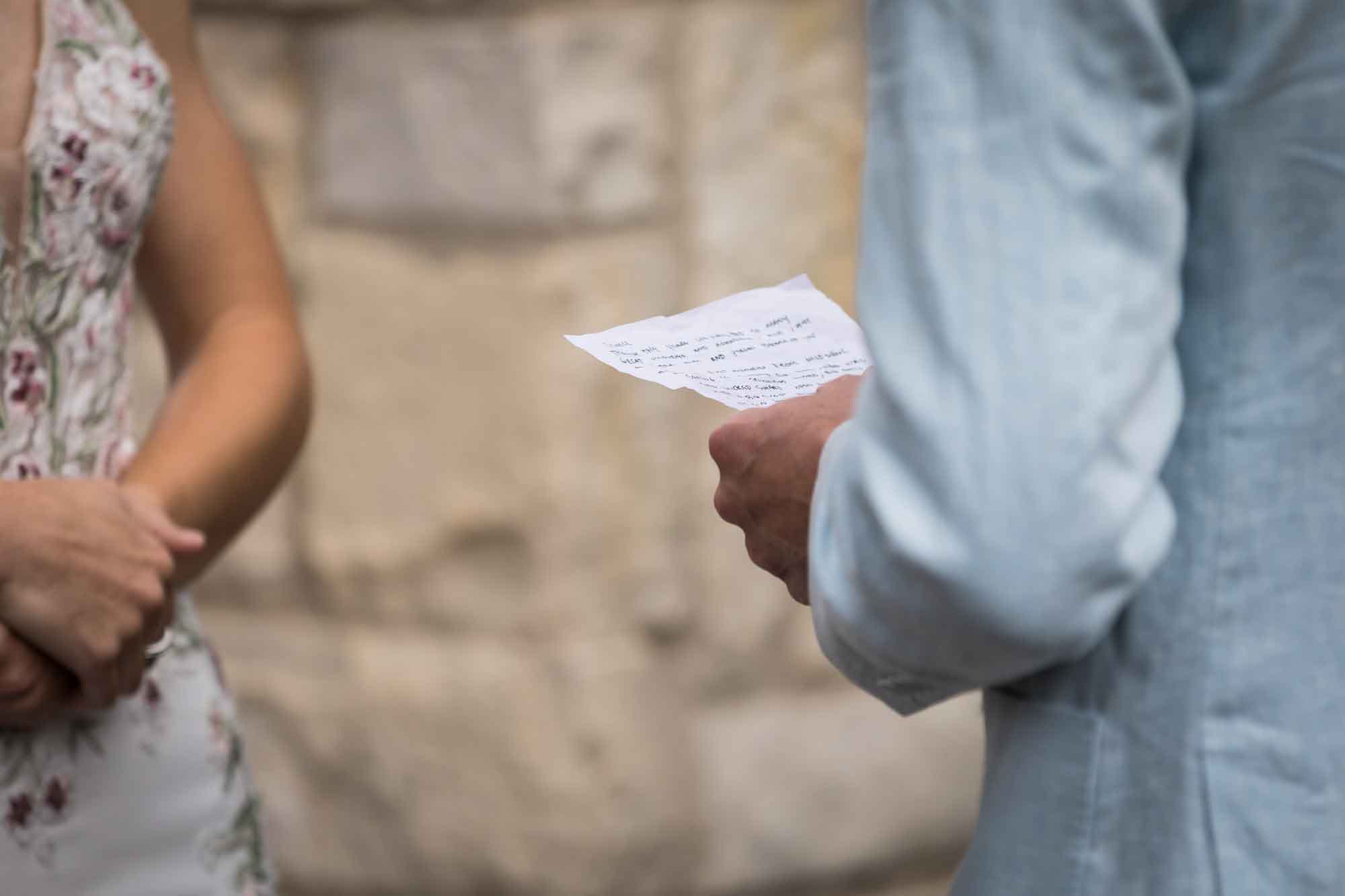 Close up on groom's handwritten vows during a Lady Bird Johnson Wildflower Center wedding