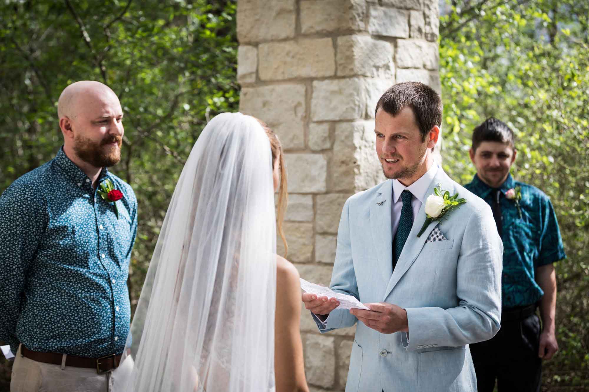 Groom reading vows from paper to bride during a Lady Bird Johnson Wildflower Center wedding
