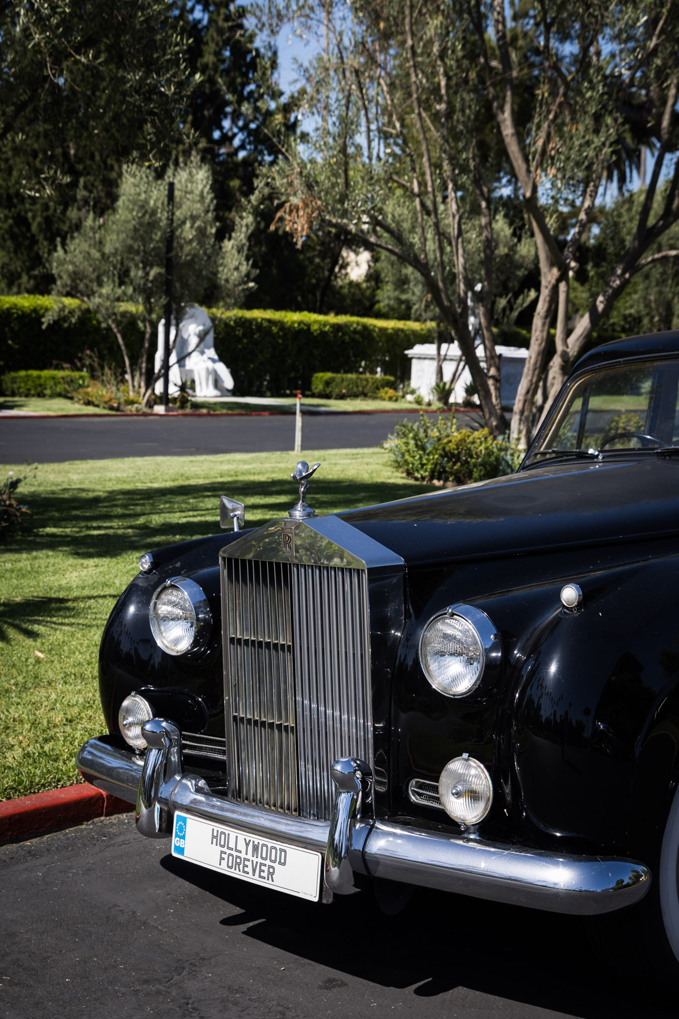 Rolls-Royce car with Hollywood Forever Cemetery license plate parked in lot