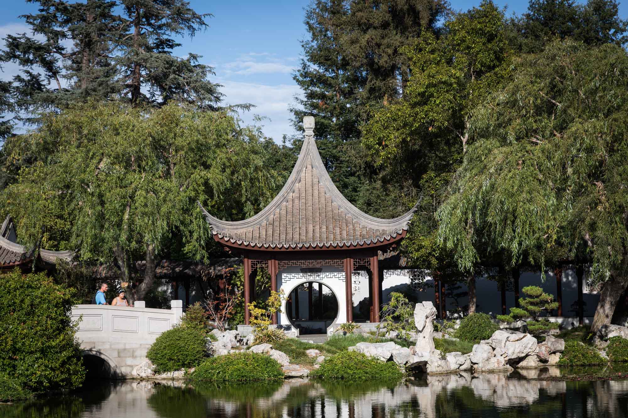 View over pond of ornate Asian-style buildings in Chinese Garden for a Huntington Gardens photo shoot guide article