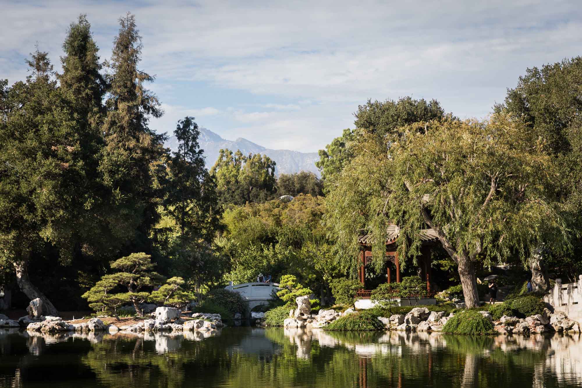 View over pond of ornate Asian-style buildings in Chinese Garden for a Huntington Gardens photo shoot guide article