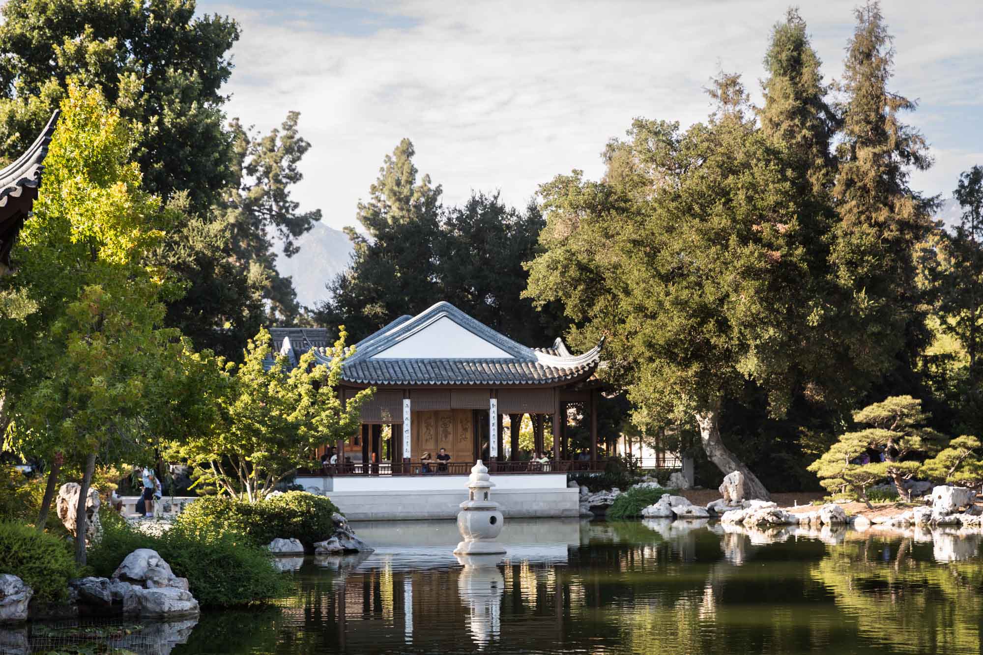 View over pond of ornate Asian-style buildings in Chinese Garden for a Huntington Gardens photo shoot guide article
