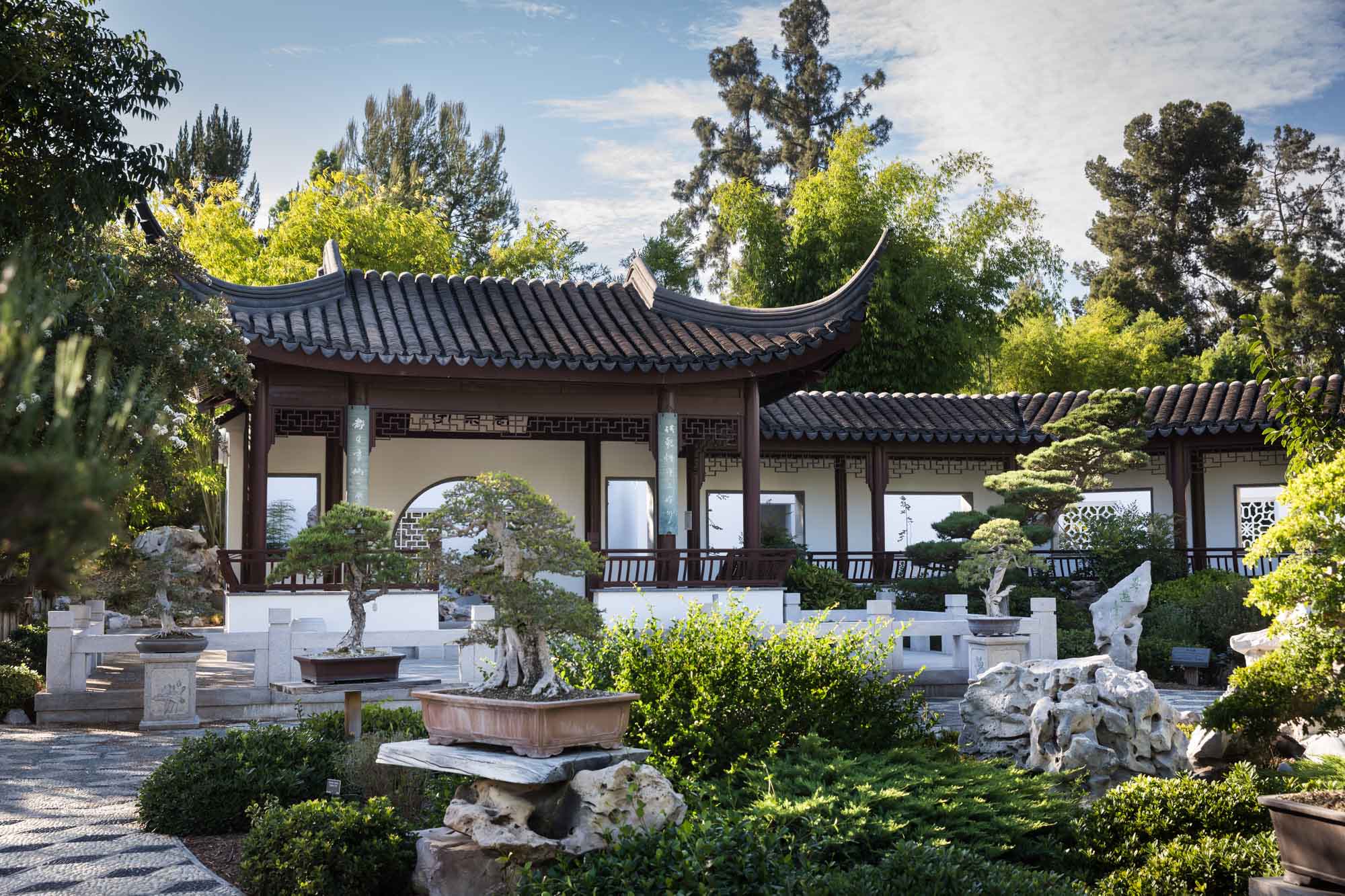 Asian-style building with pitched roof in topiary terrace in Chinese Garden for a Huntington Gardens photo shoot guide article