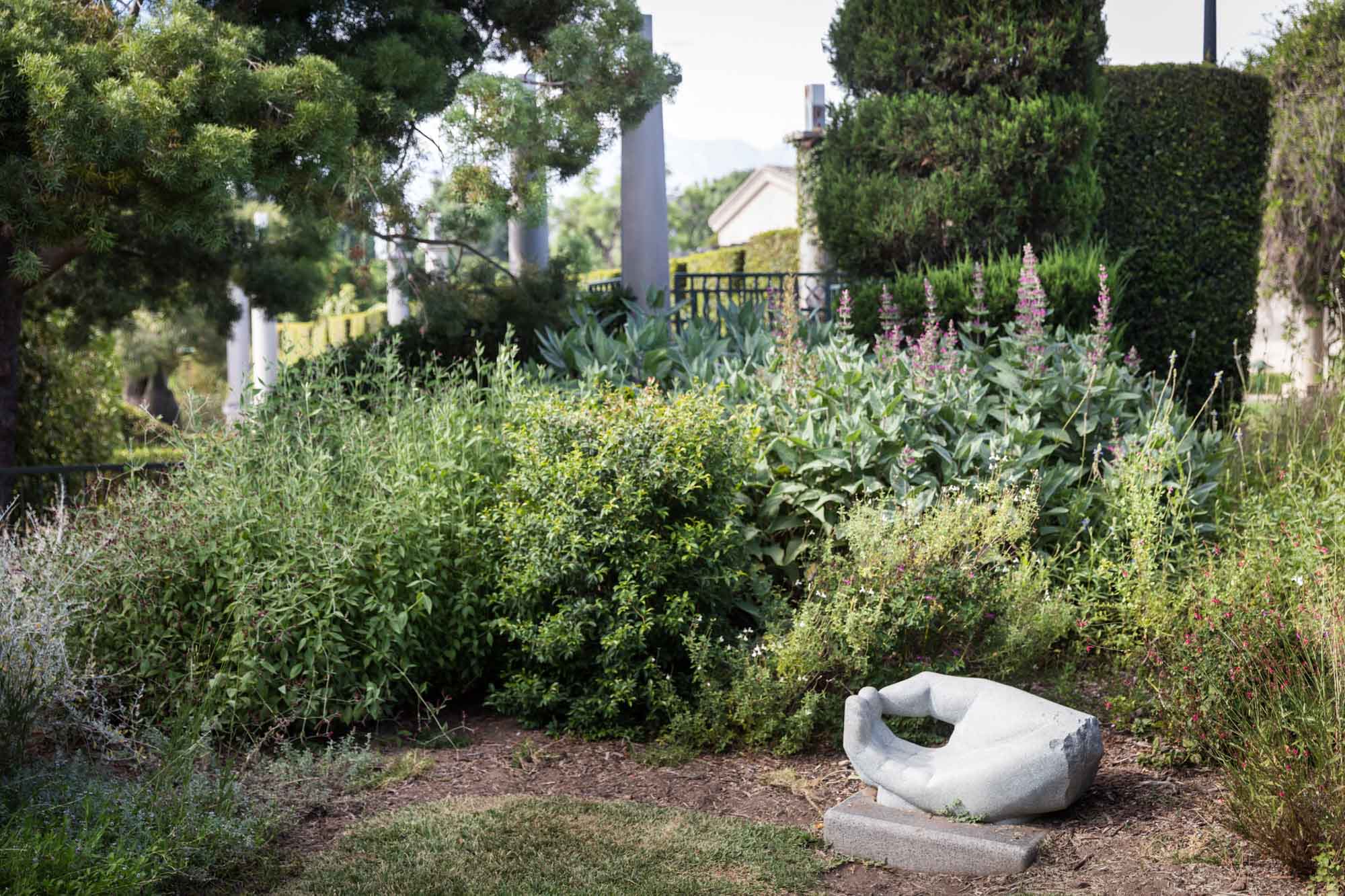 White hand sculpture and plants in the Children's Garden for a Huntington Gardens photo shoot guide article