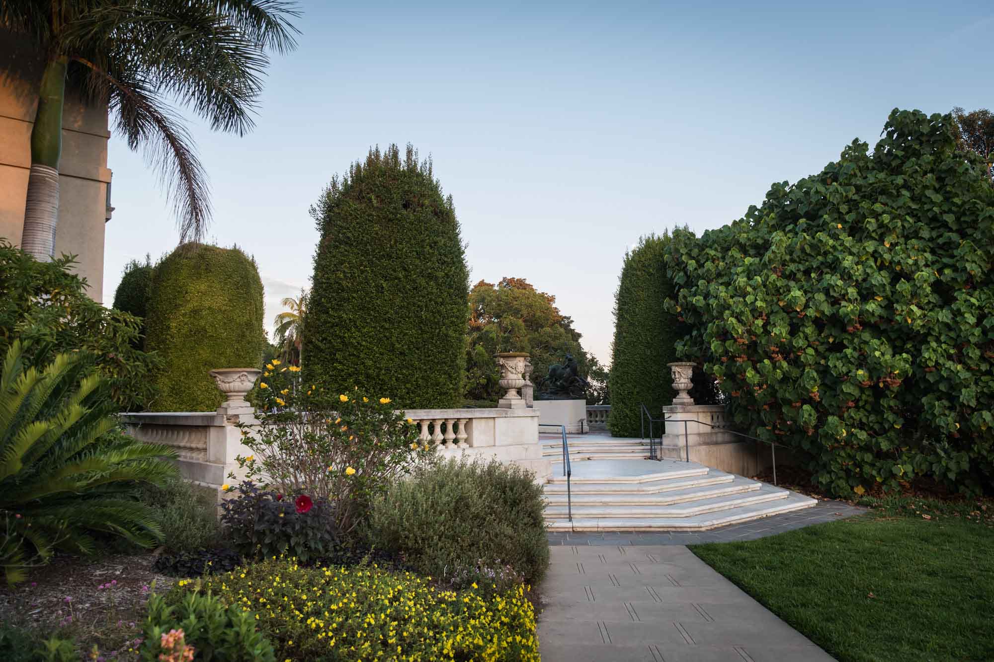 Stone terrace and steps of the Huntington Art Gallery building and surrounding bushes for a Huntington Gardens photo shoot guide article