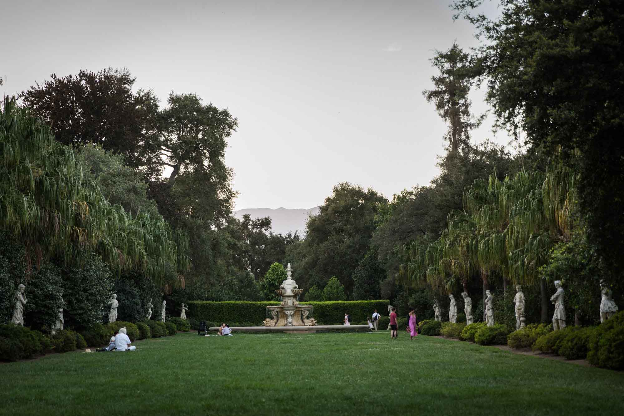 North Vista sculpture garden with rows of classical stone sculptures down a grass passageway leading to a fountain for a Huntington Gardens photo shoot guide article