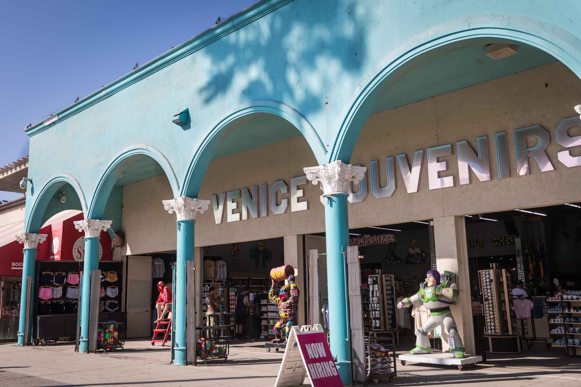 Aqua blue front of the Venice Market with a mirrored sign saying 'Venice Souvenirs' for an article on Venice Canals engagement photos