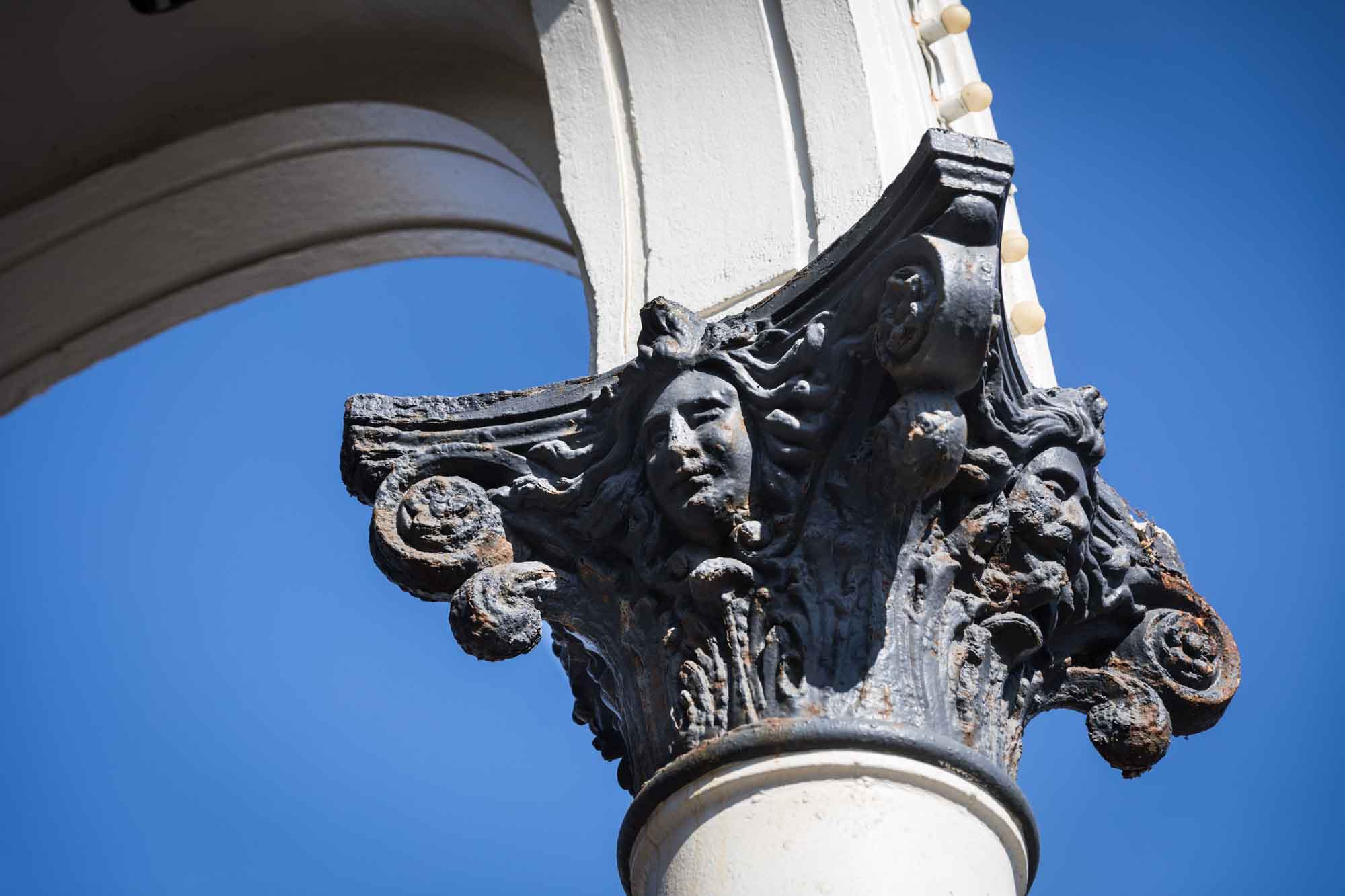 Top of classic column painted in black showing rust in Venice Beach for an article on Venice Canals engagement photos