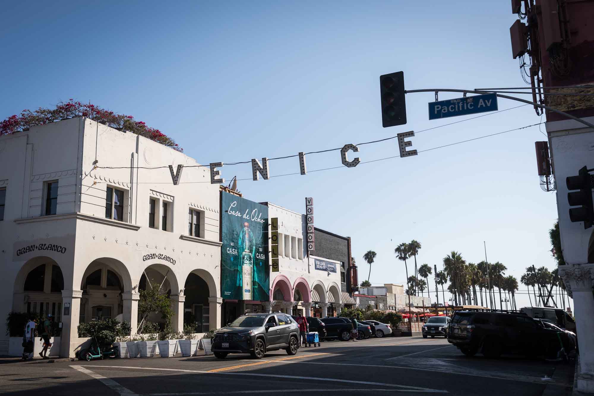 The Venice sign at the corner of Windward and Pacific Avenues with cars below for an article on Venice Canals engagement photos