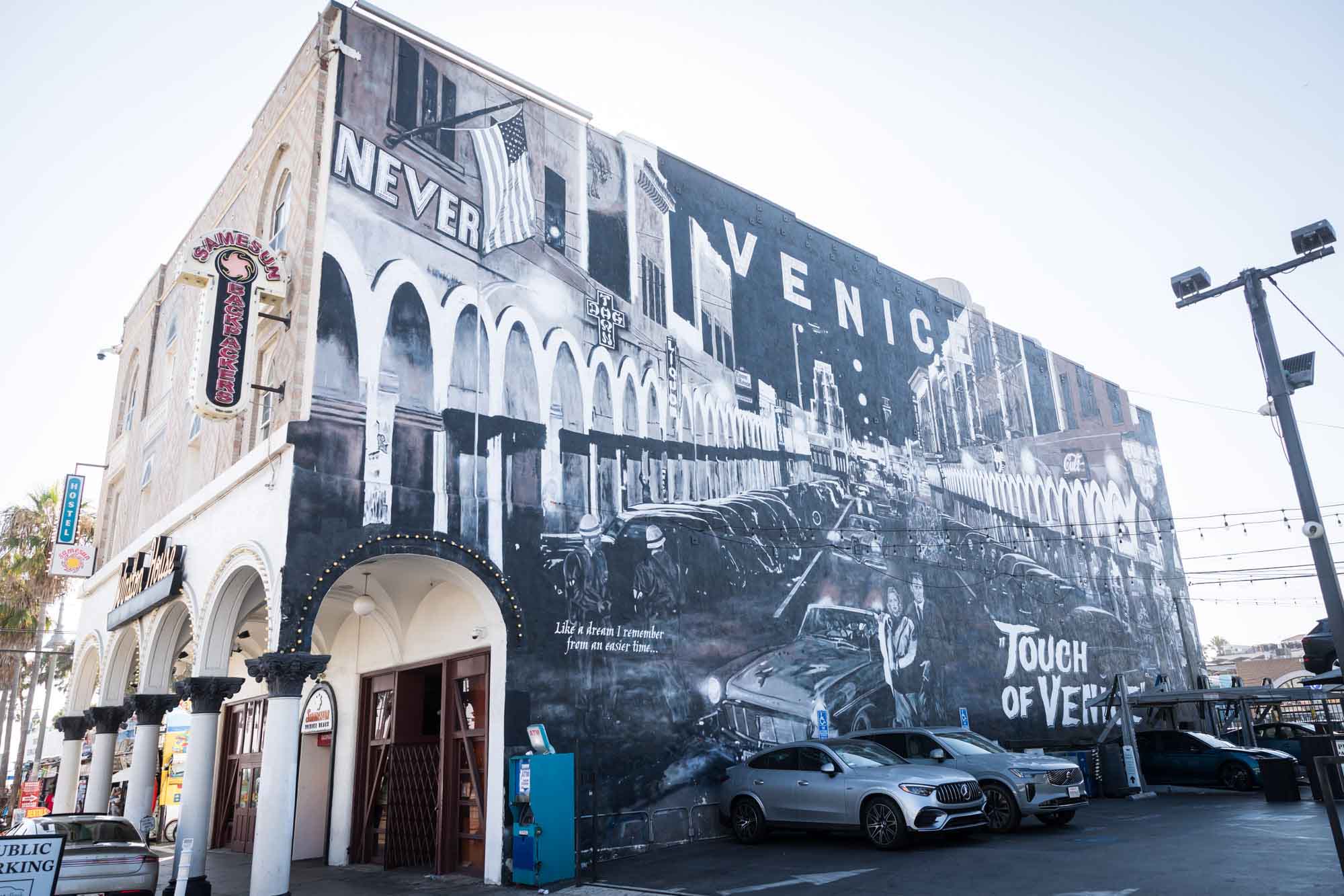 Large building with black and white mural showing Venice and 'Touch of Venice' for an article on Venice Canals engagement photos