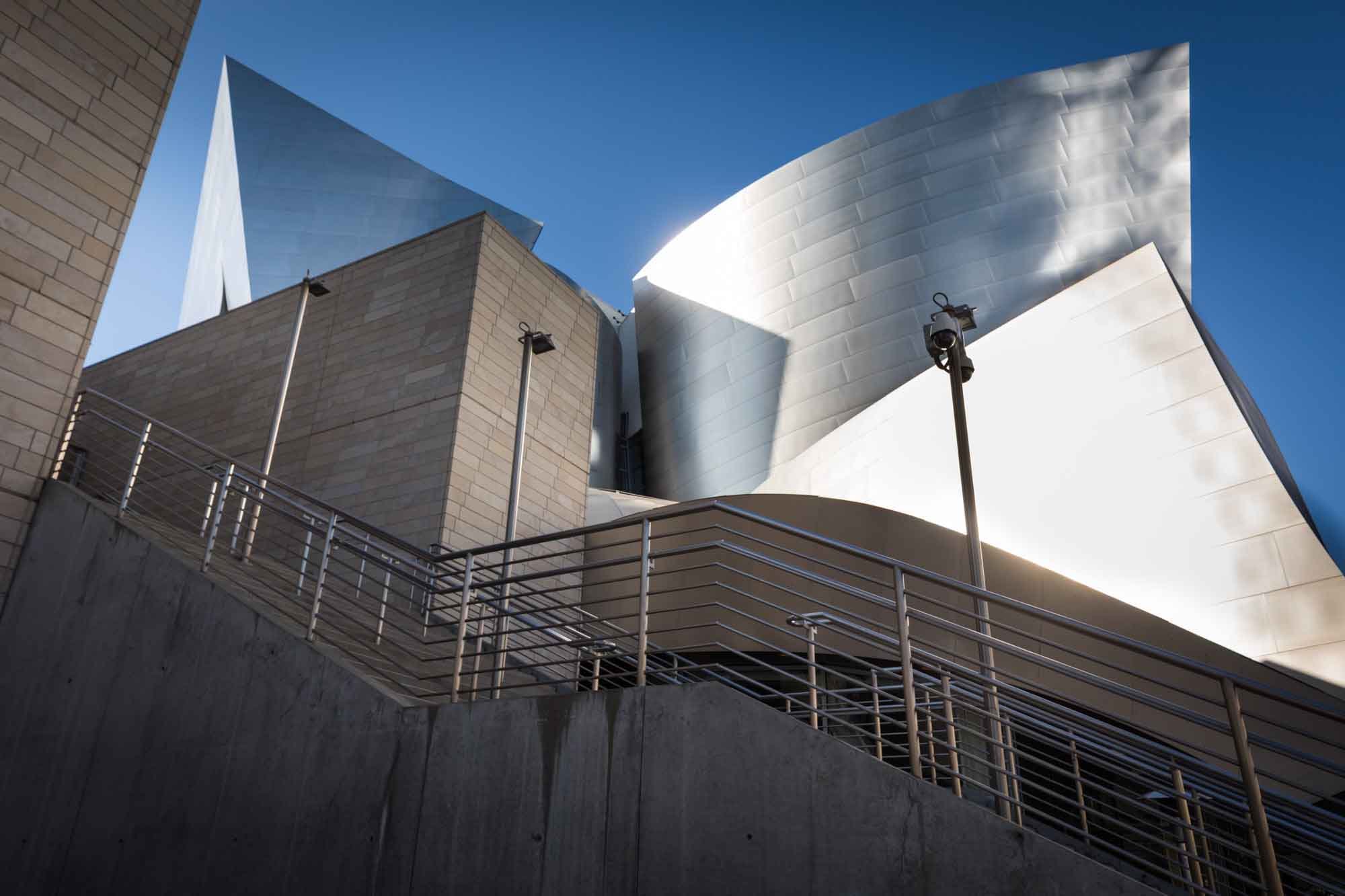 Grand side staircase in front of silver and brick sides of Walt Disney Concert Hall for an article on Walt Disney Concert Hall photos