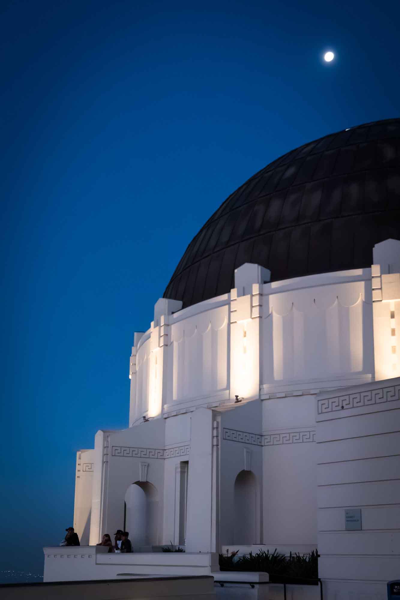 East Terrace and roof of Griffith Observatory with moon in background before sunrise for an article on where to propose at the Griffith Observatory