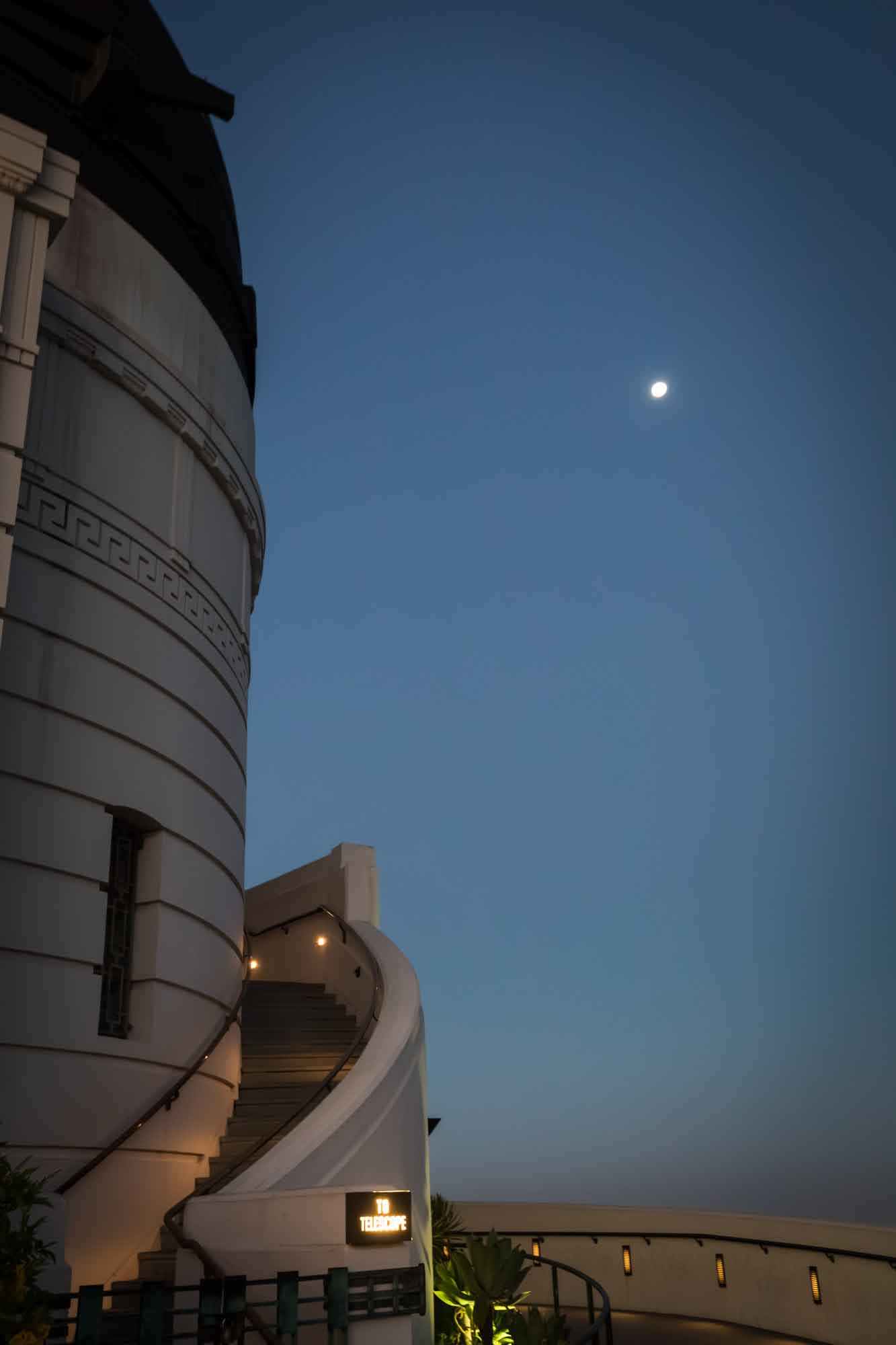 West side of Griffith Observatory with moon in background before sunrise for an article on where to propose at the Griffith Observatory