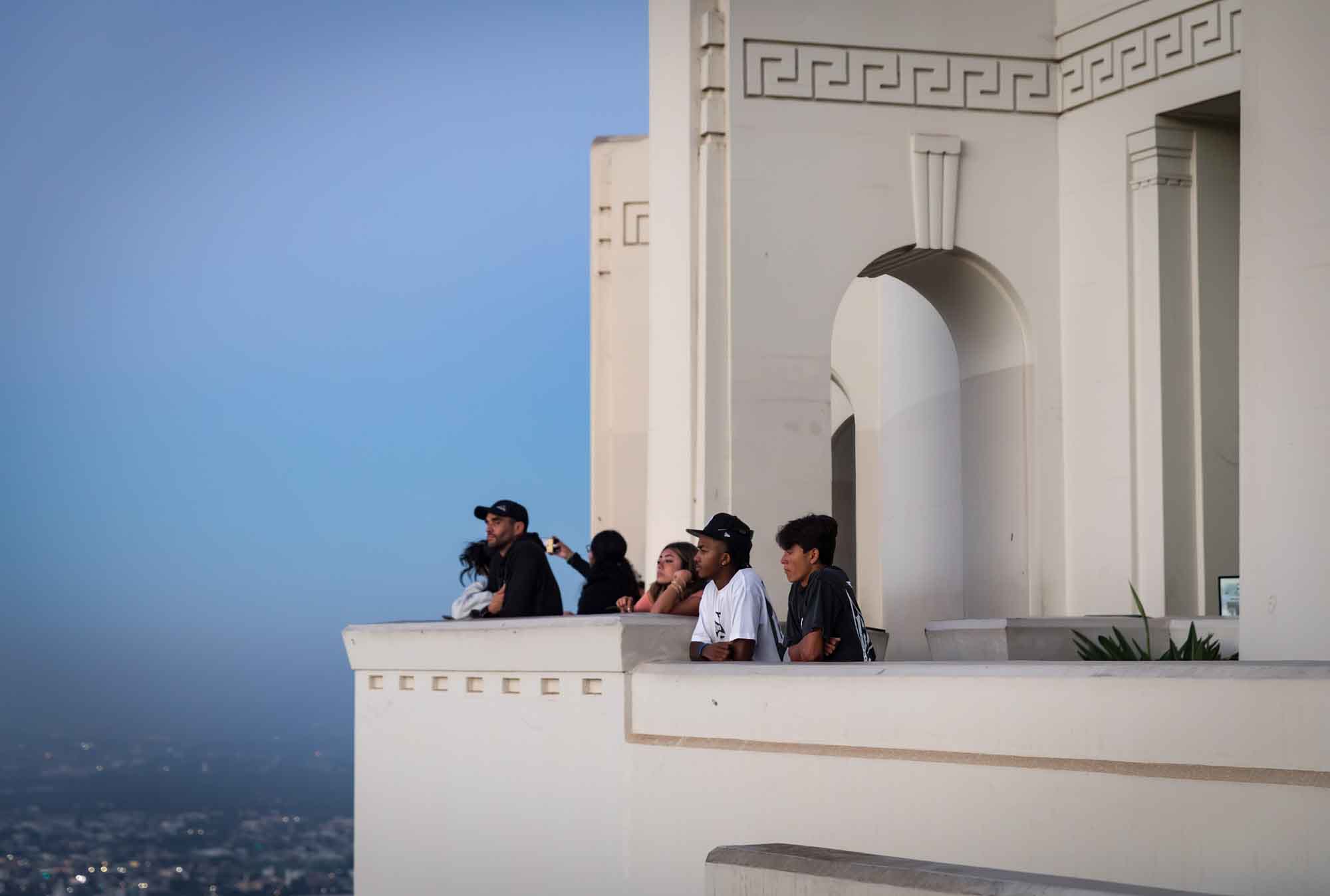 Visitors standing on the East Terrace waiting for sunrise for an article on where to propose at the Griffith Observatory