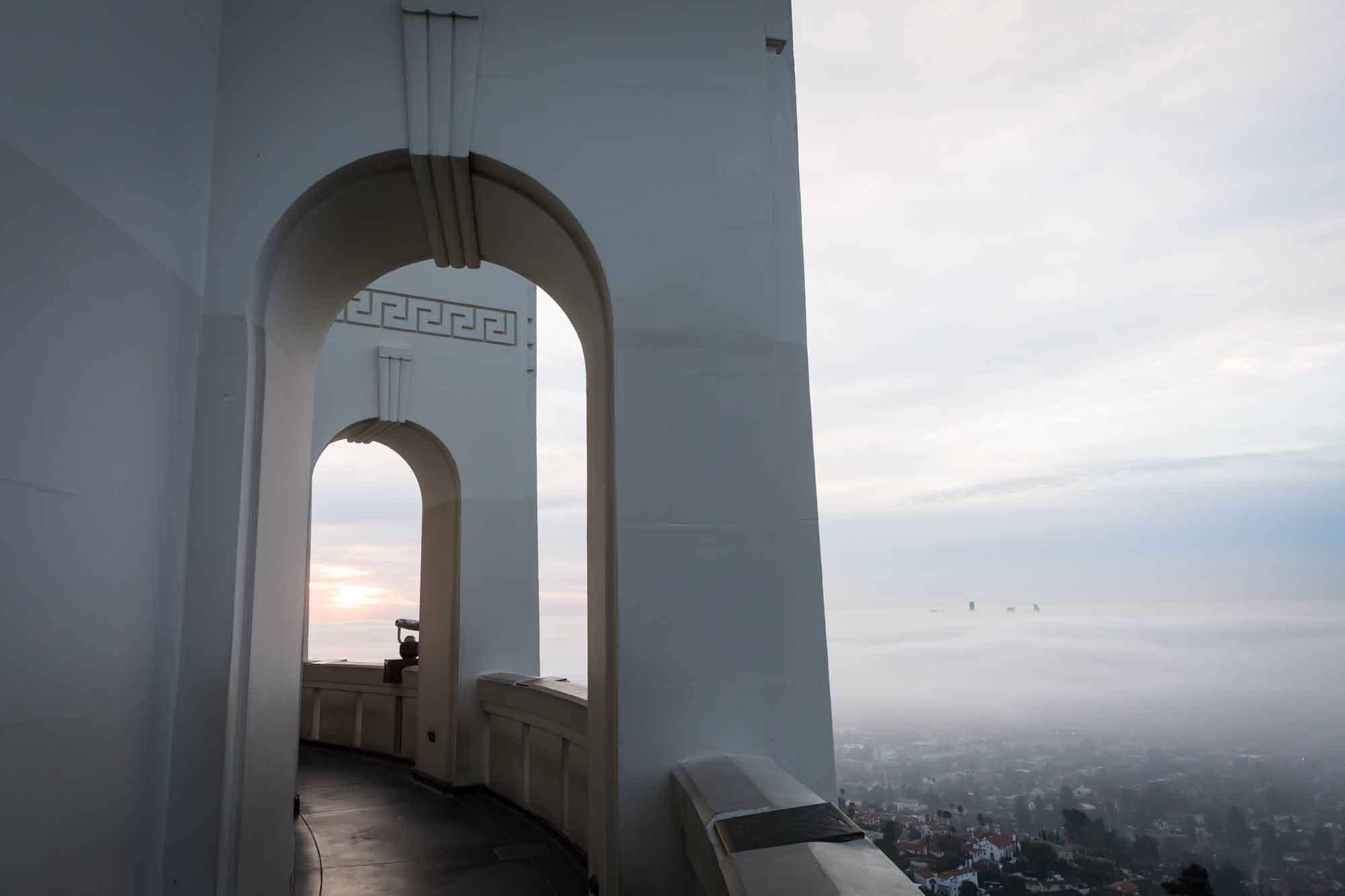 View through arches on roof of Griffith Observatory at sunrise for an article on where to propose at the Griffith Observatory