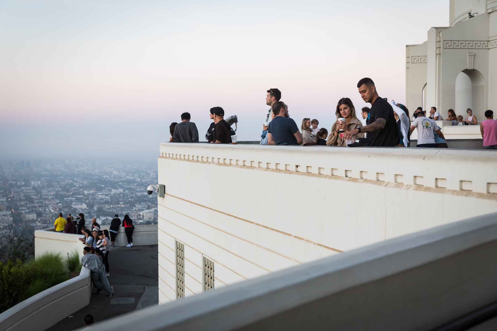 Visitors standing on the East Terrace waiting for the sun to rise for an article on where to propose at the Griffith Observatory
