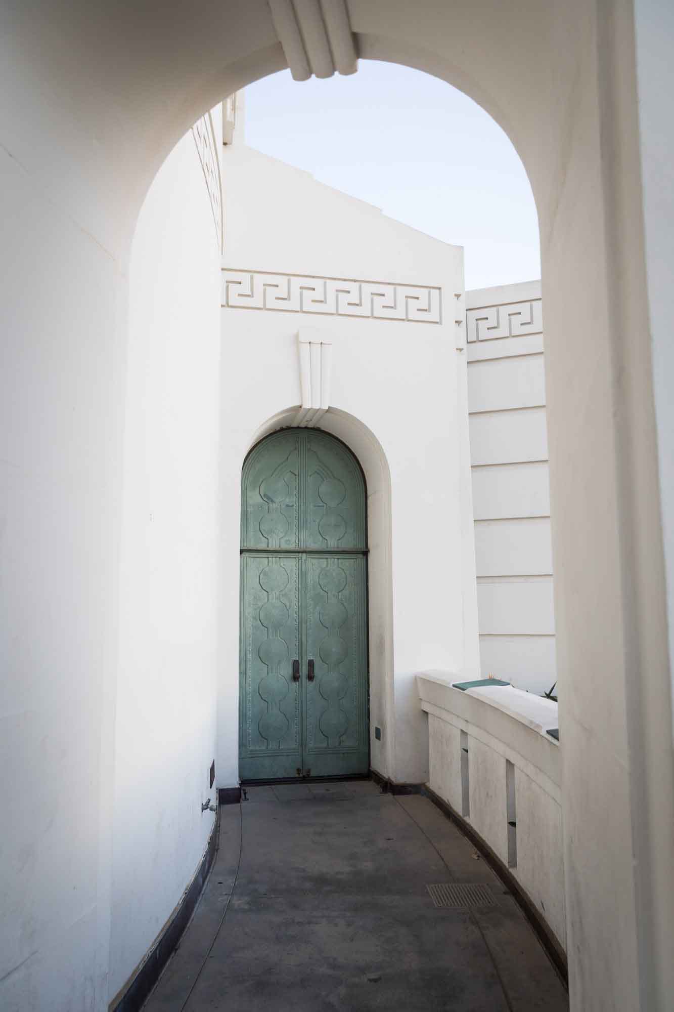 Metal door in Art Deco style with green patina for an article on where to propose at the Griffith Observatory
