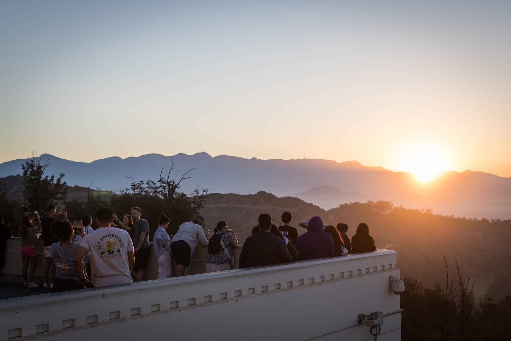 Visitors standing on the East Terrace roof watching the sun rise for an article on where to propose at the Griffith Observatory