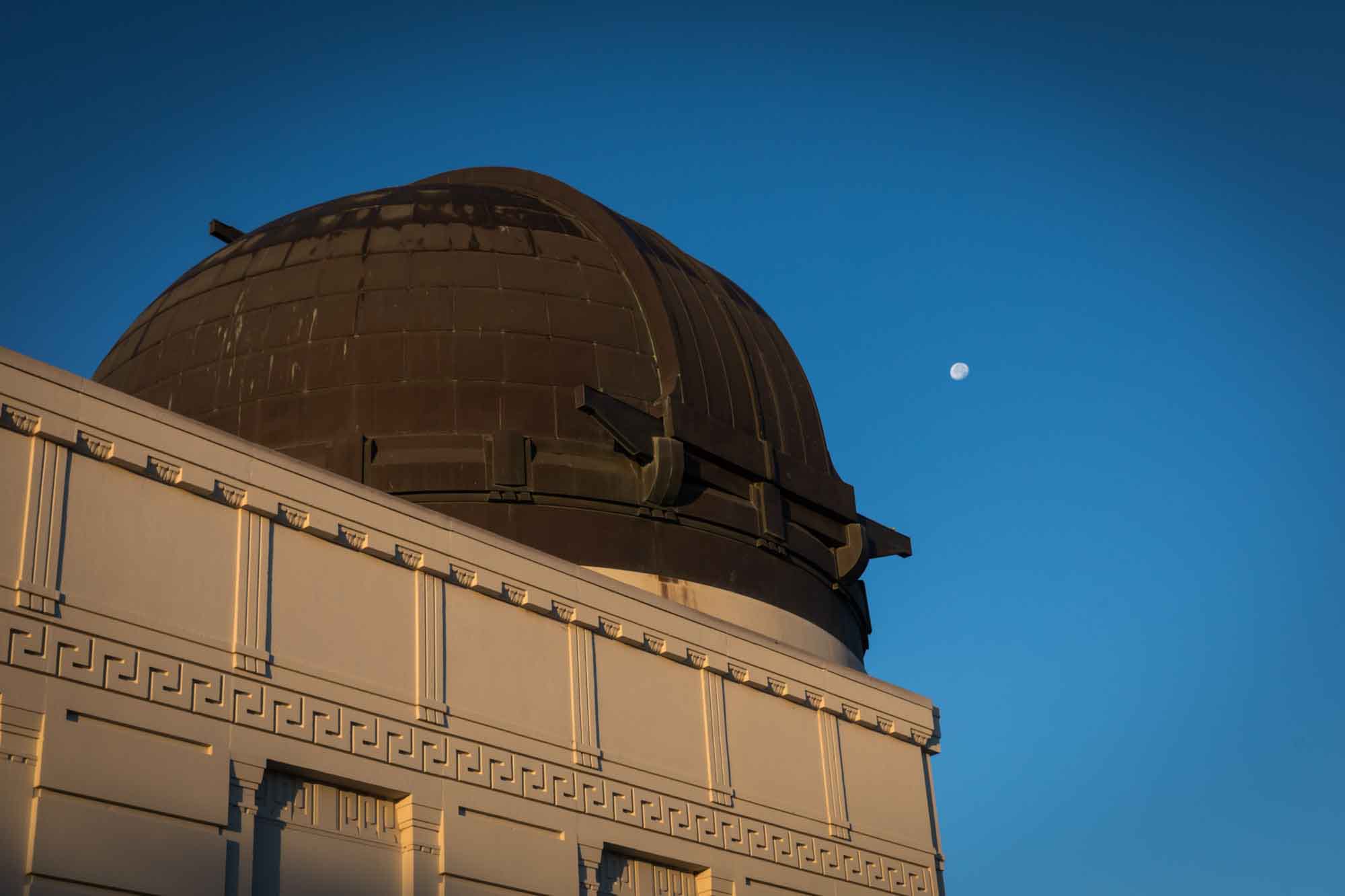 Griffith Observatory just after sunrise with moon in the background for an article on where to propose at the Griffith Observatory
