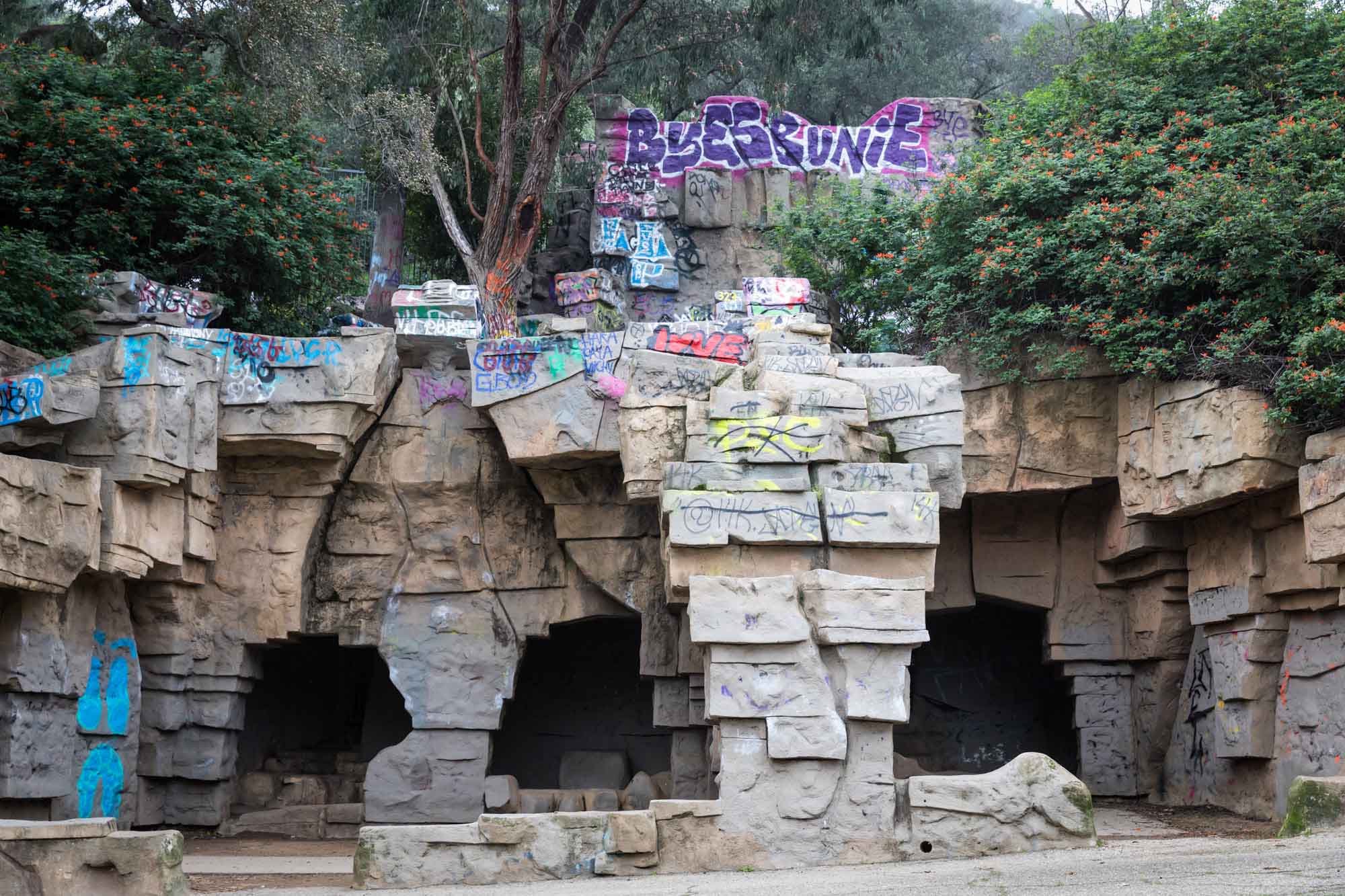 Large animal enclosures with colorful graffiti in Old Los Angeles Zoo in Griffith Park for an article on where to propose at the Griffith Observatory