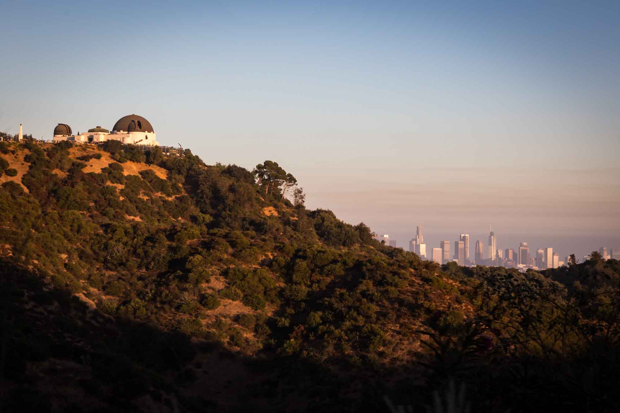 View of Griffith Observatory and Los Angeles skyline at sunset for an article on where to propose at the Griffith Observatory